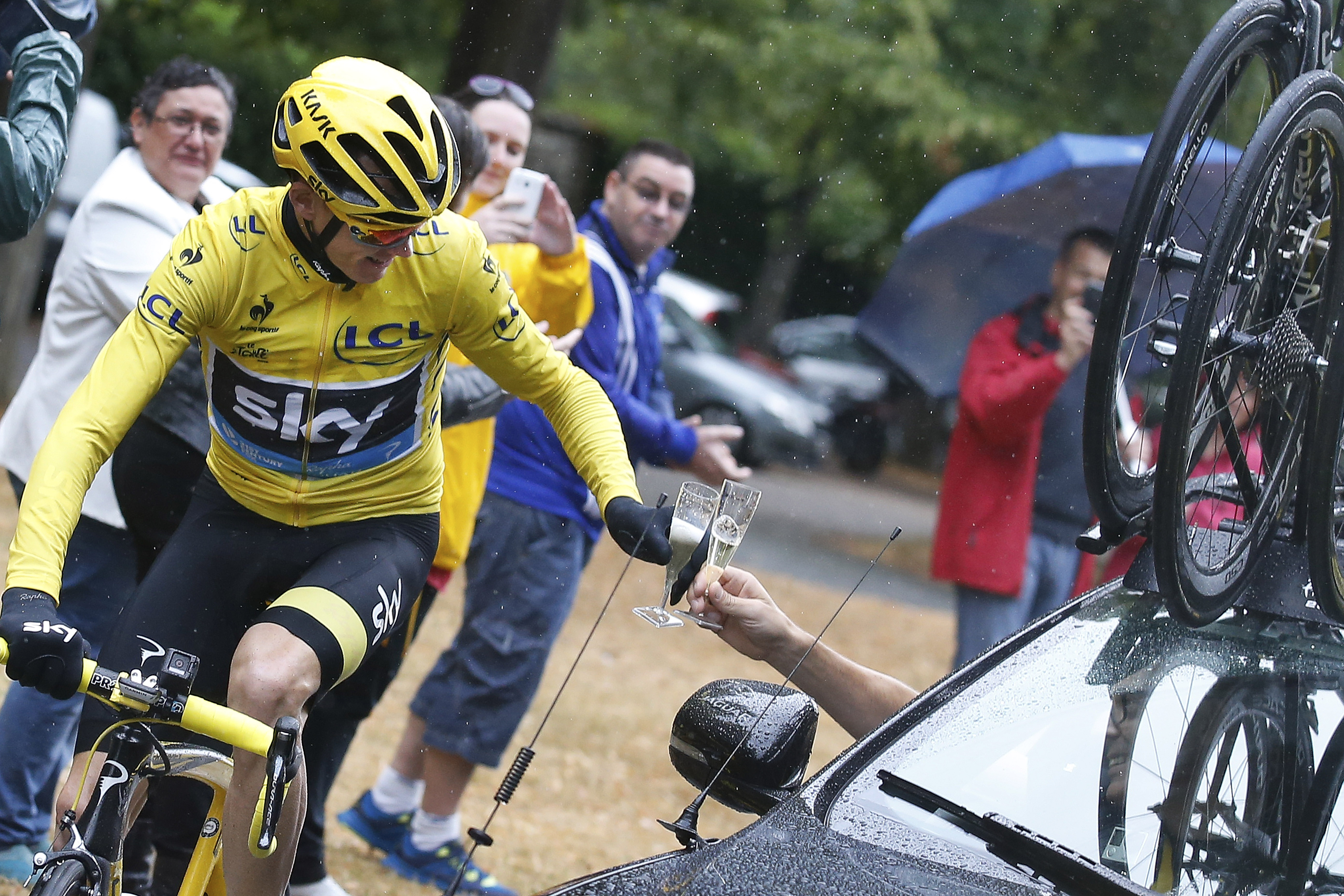 Britain's Chris Froome enjoys the traditional toast of champagne on the last stage of the Tour de France into Paris on Sunday. Photos: AP