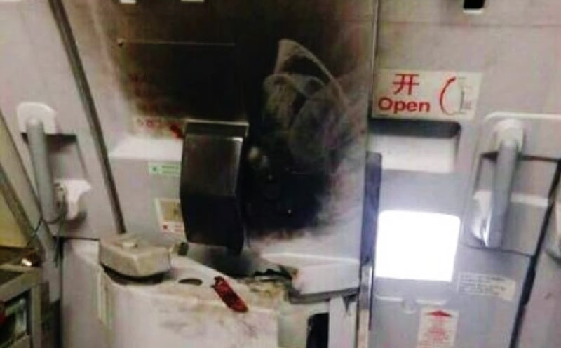 The passenger attempts to set a fire using petrol and a cigarette lighter. Photo: Weibo