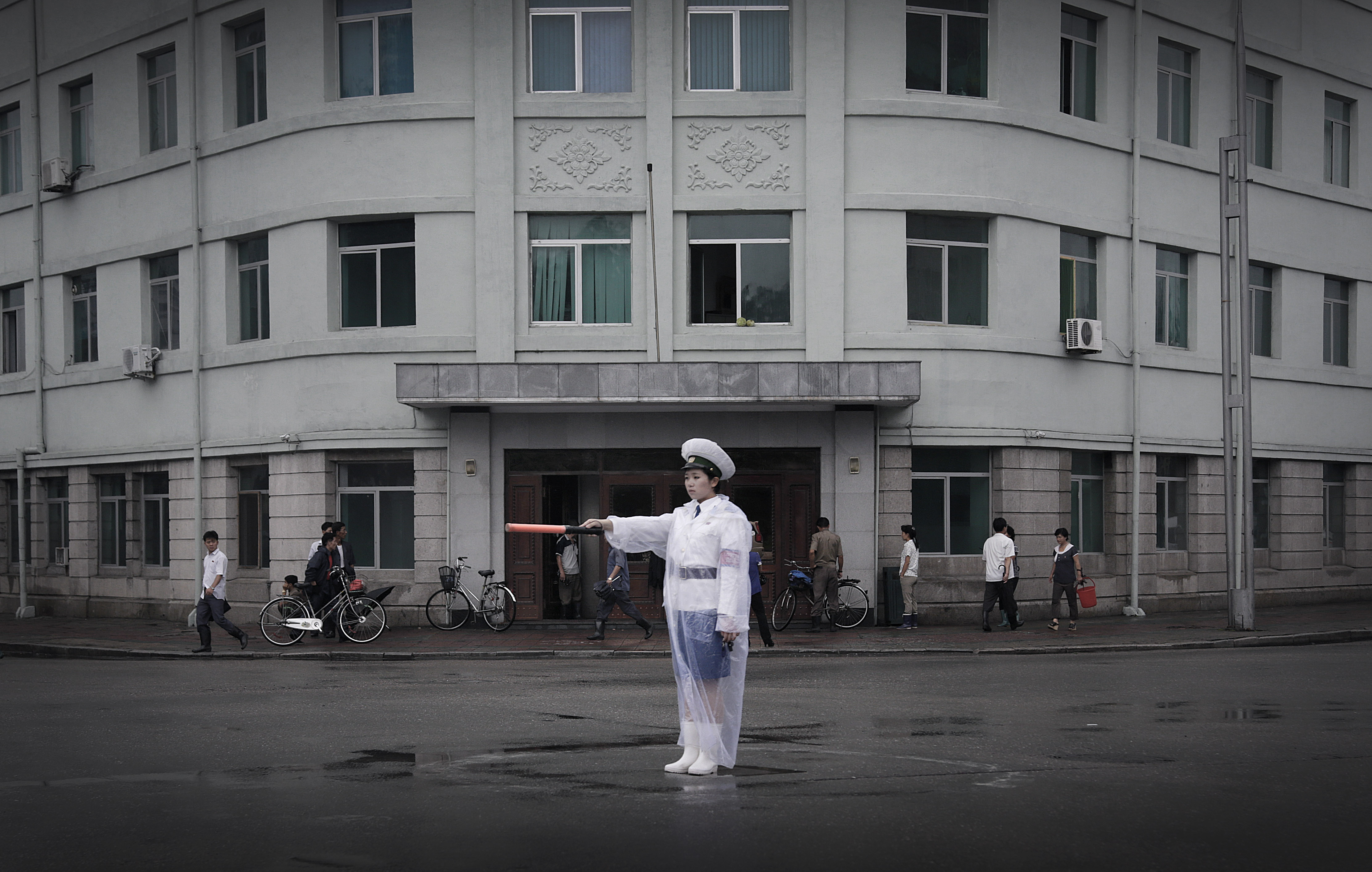 A traffic policewoman dressed in a raincoat directs traffic in Pyongyang, North Korea, as an economic downturn in neighbouring China could severely hit the country. Photo: AP