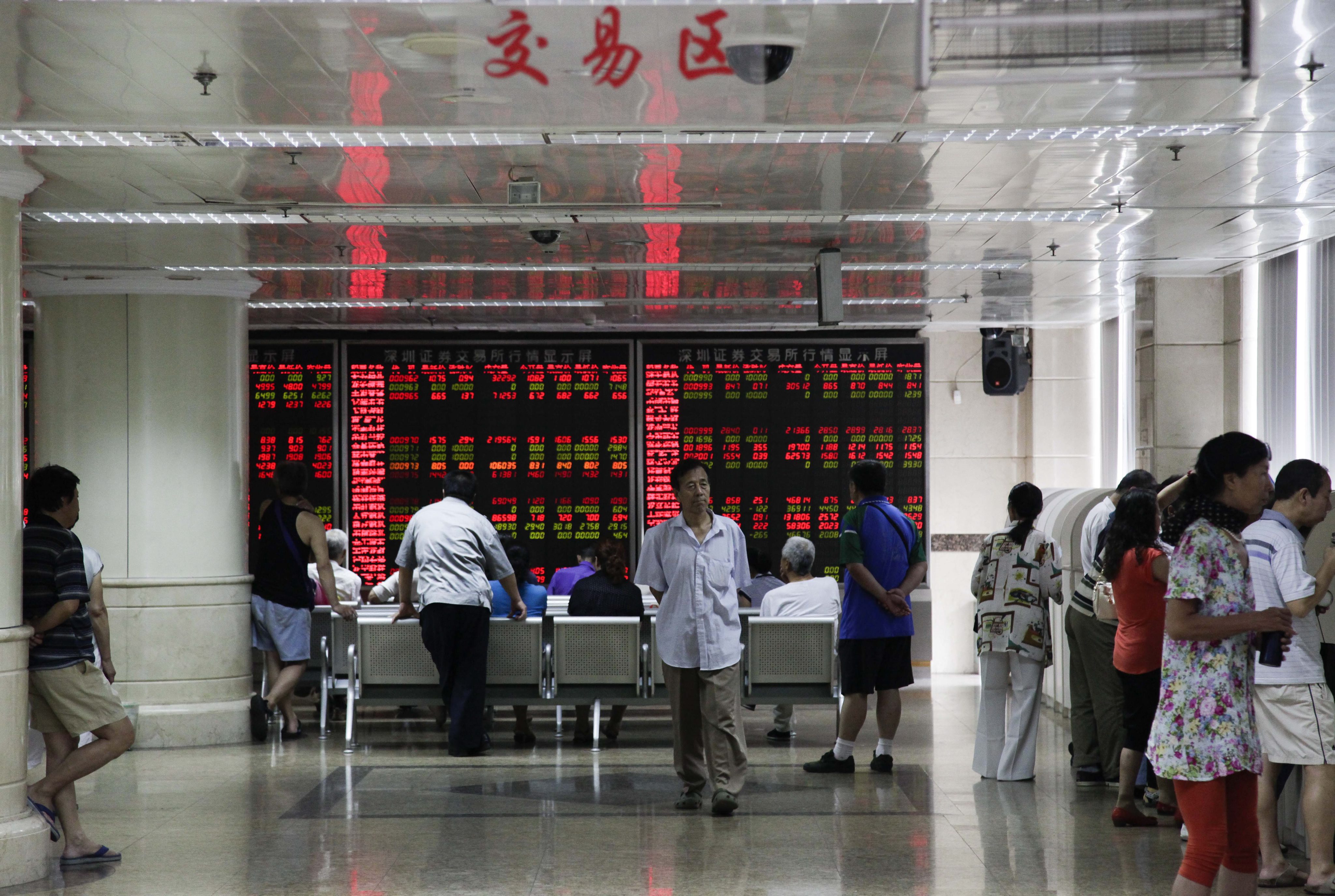An electronic board at a brokerage house in Beijing shows share prices on the Shanghai stock exchange. Photo: EPA 
