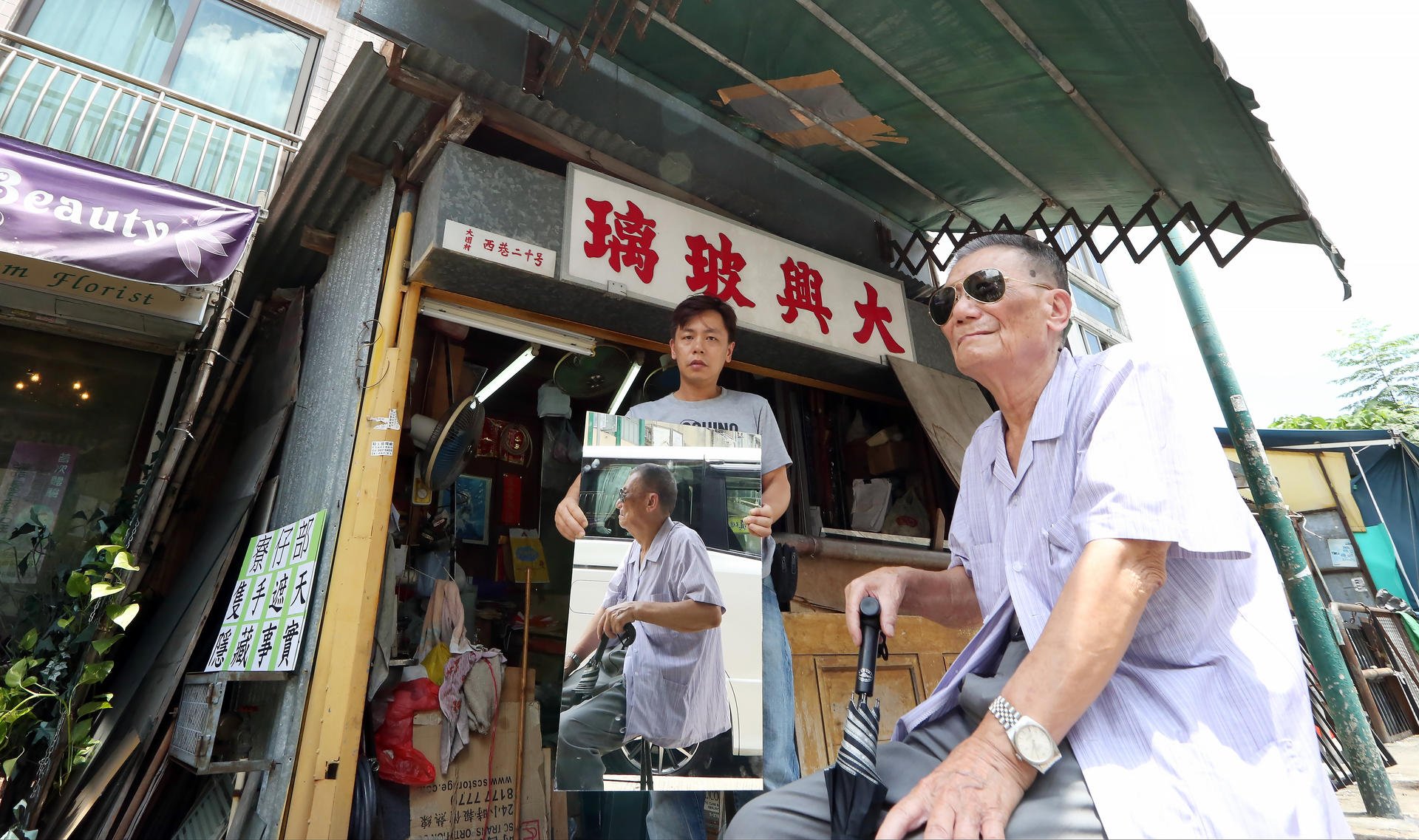 Lew Kay-nang (right) with his son Lew Kam-ming at the squatter's hut. Photo: Nora Tam