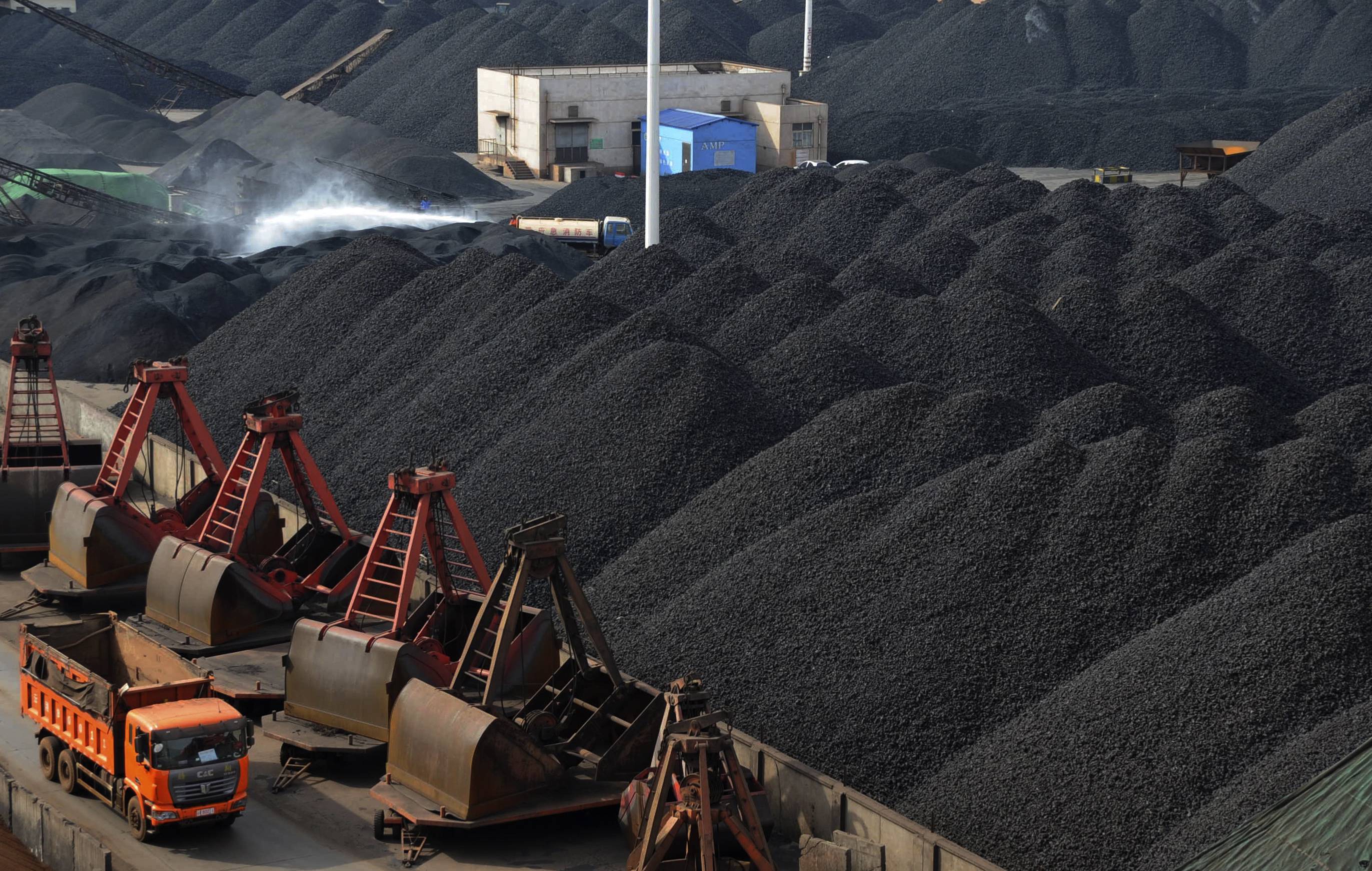 Trucks haul mountains of coal in China as imports of the material surged in July although most in the trade doubt it can be sustained. Photo: Reuters
