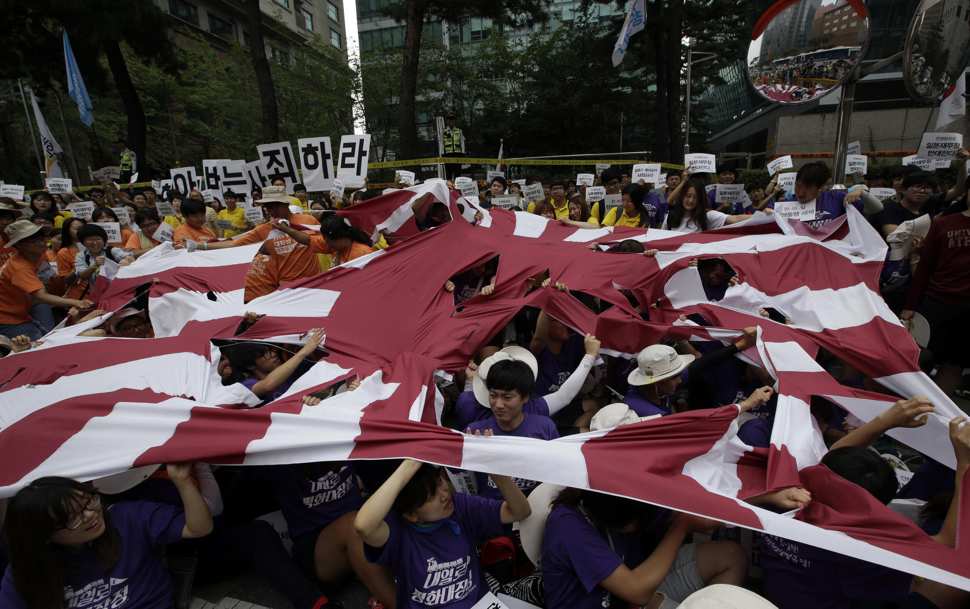 In Seoul, protesters tore up a flag. Photo: AP