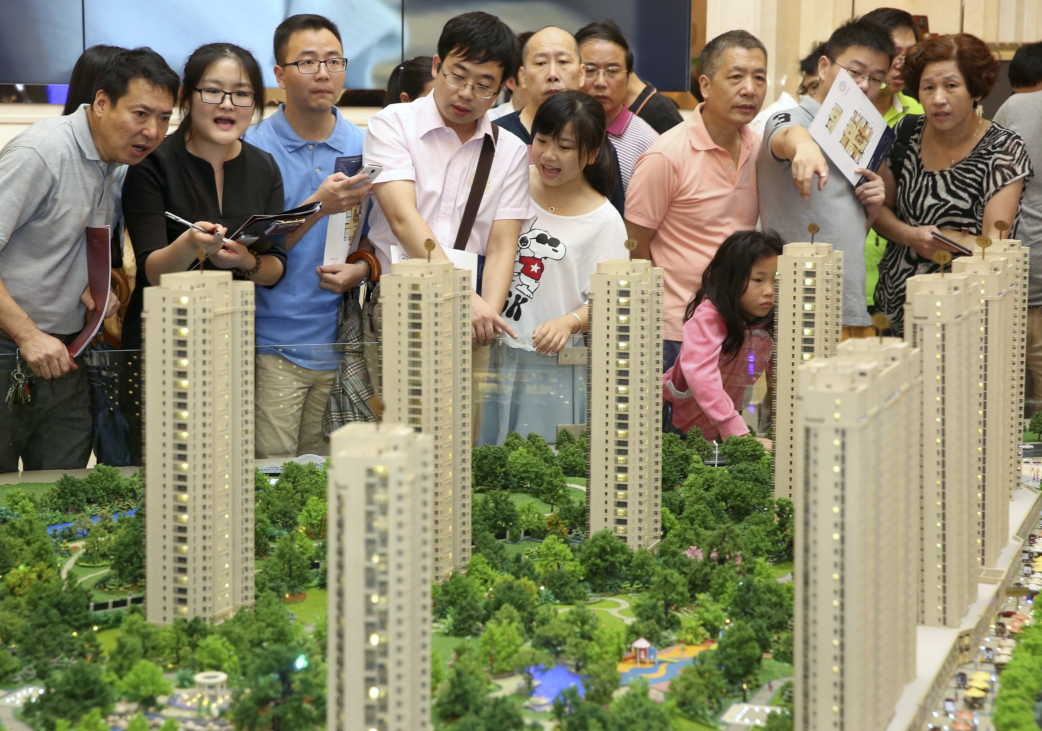 Customers look at a model of Longfor Properties project in Zhejiang province in China. Photo: Reuters 