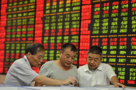 Investors in Fuyang, Anhui province, check how their stocks fared on Friday. Photo: Reuters
