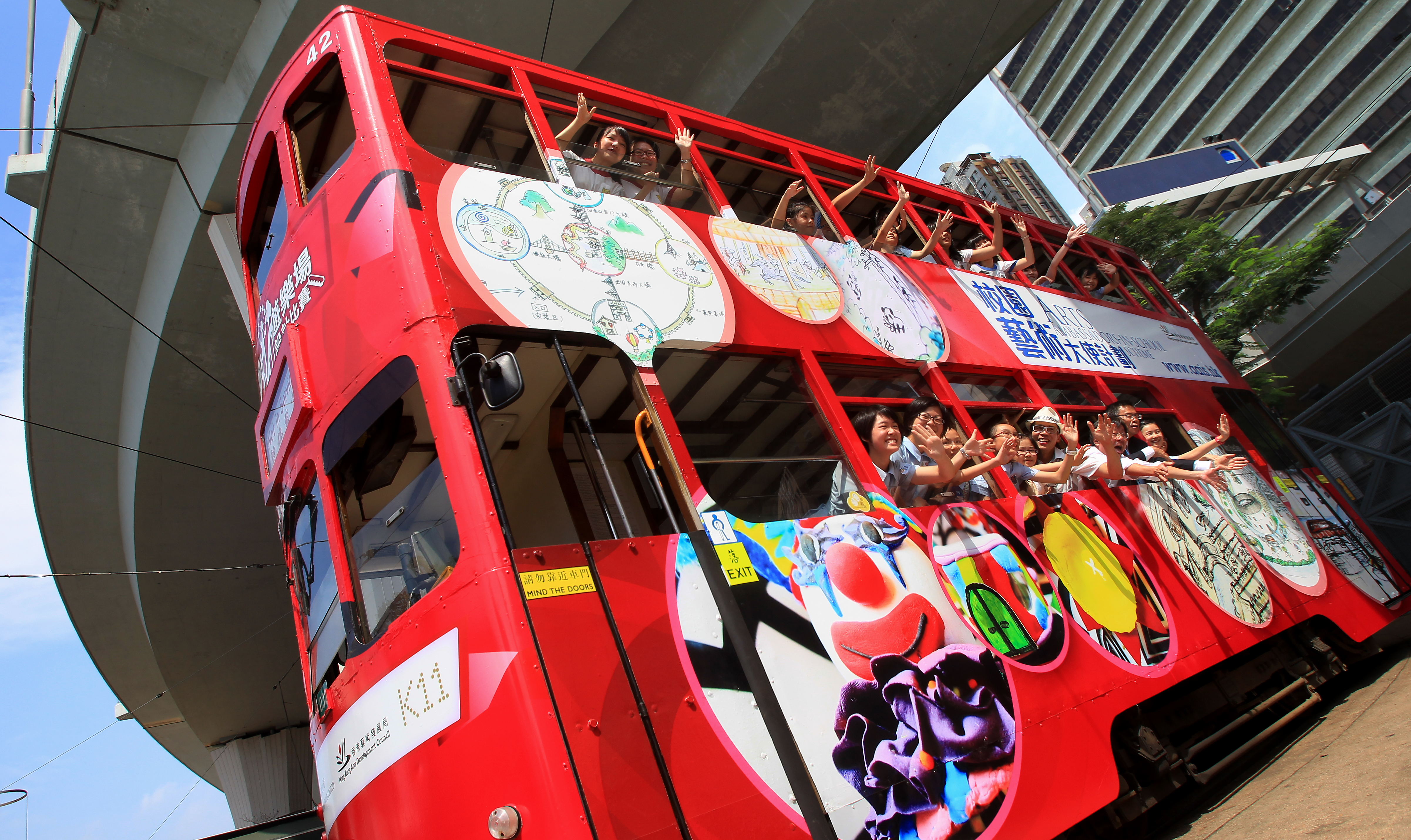 Hong Kong students ride a tram bearing their art designs during a cultural event. Photo: Jonathan Wong