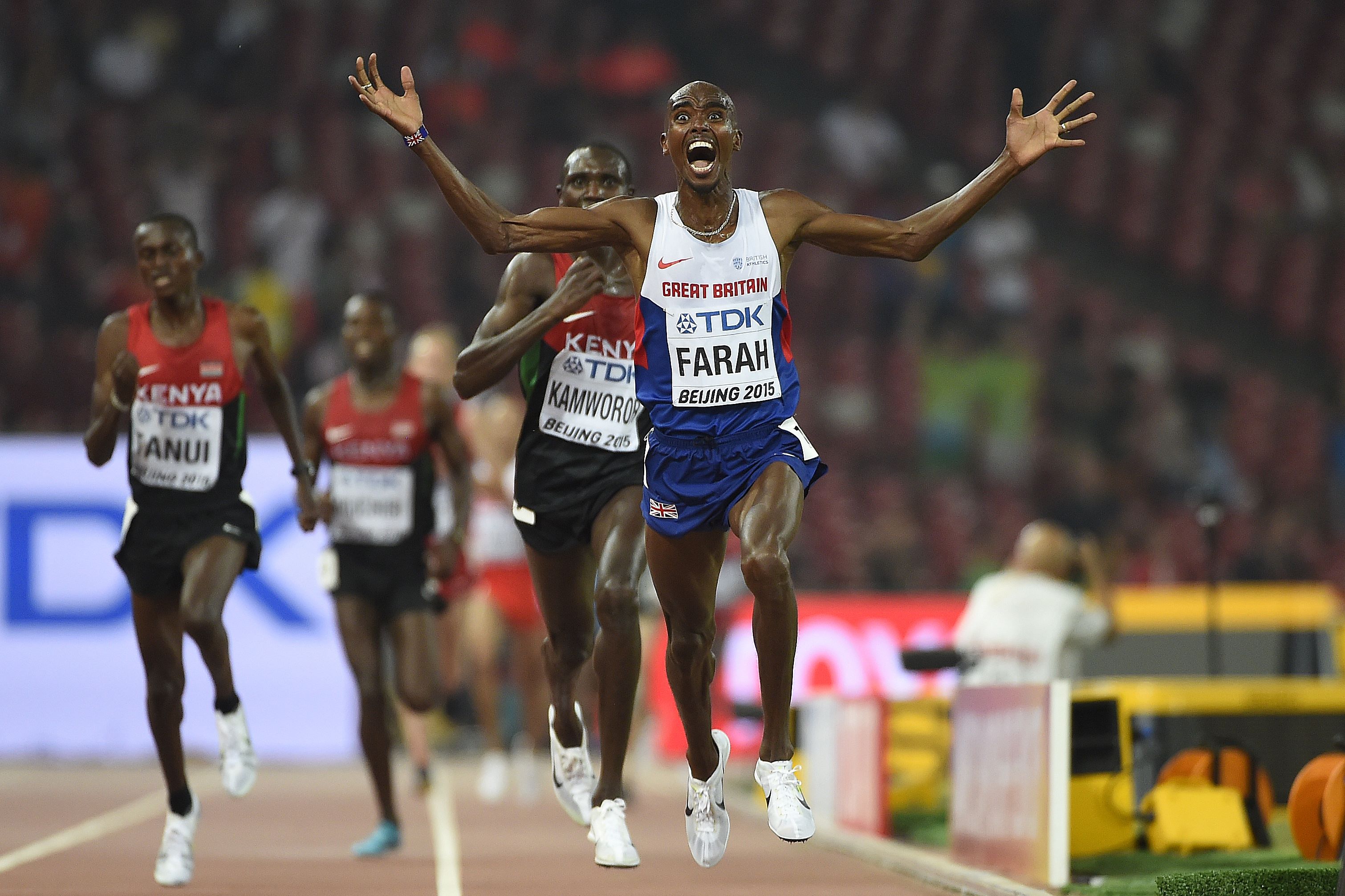 Mo Farah celebrates as he wins a pulsating 10,000m race on the first day of the world athletics championships in Beijing. Photos: AFP