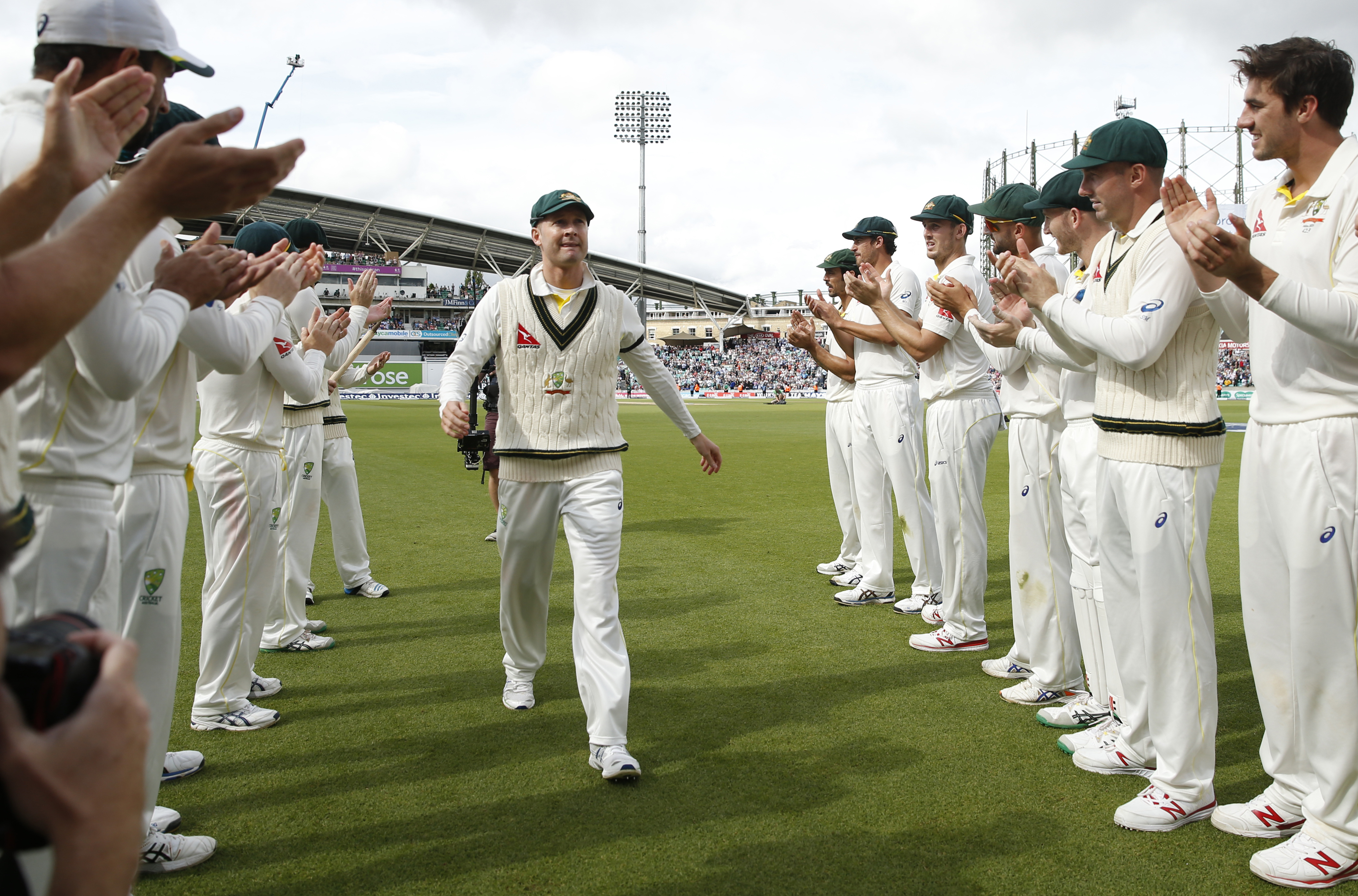 Australia captain Michael Clarke receives a guard of honour from his teammates as he leaves the field after Australia won the fifth test at The Oval. Photo: AP