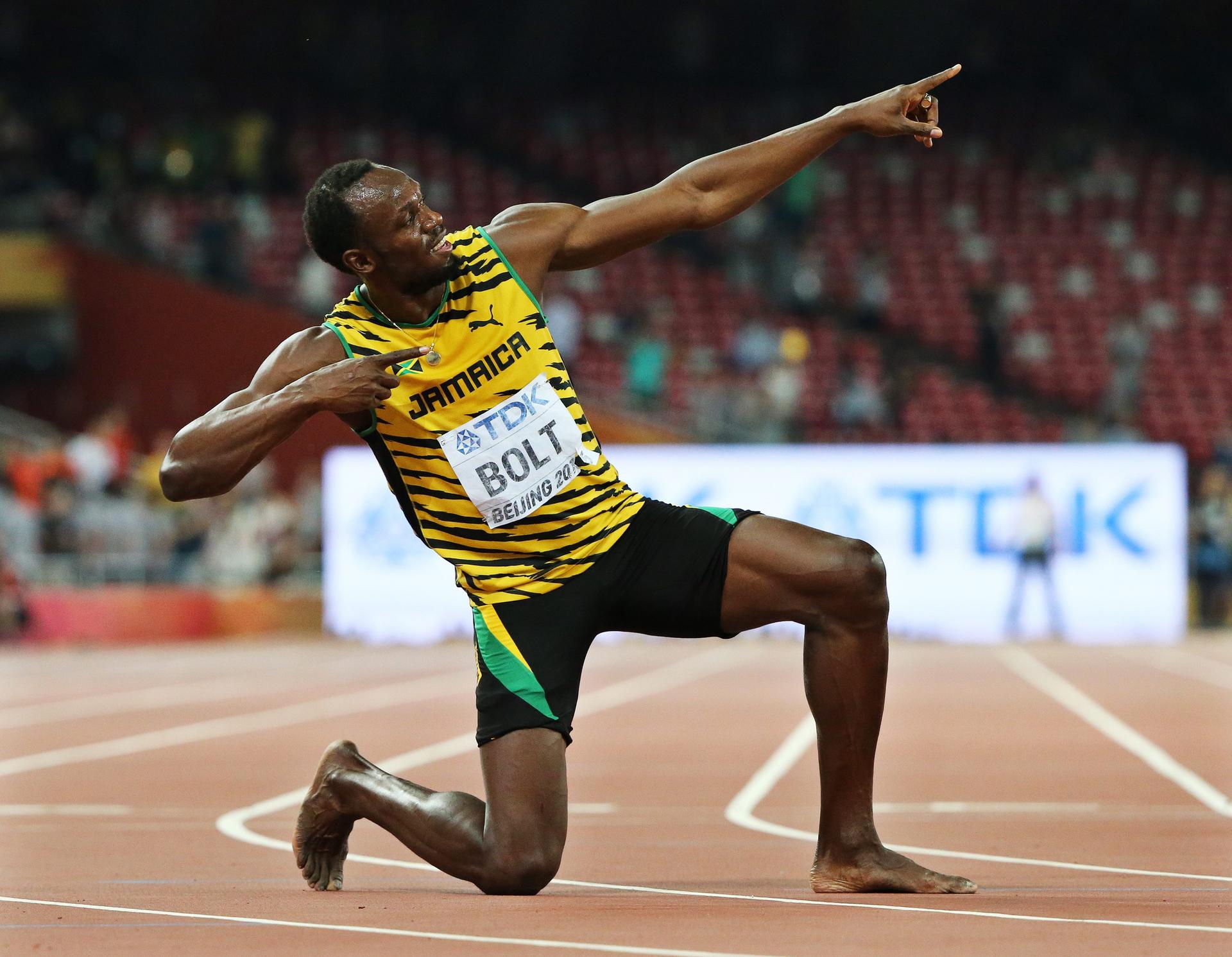 Jamaican sprinter Usain Bolt celebrates winning the 200m men's world championship title with his signature pose at the Bird's Nest stadium in Beijing. Photo: EPA