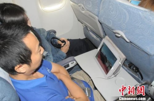Passengers on Thursday's Air China flight from Beijing to the city of Sanya, on Hainan Island, were the first to watch a live in-flight TV broadcast. Photo: China News Service