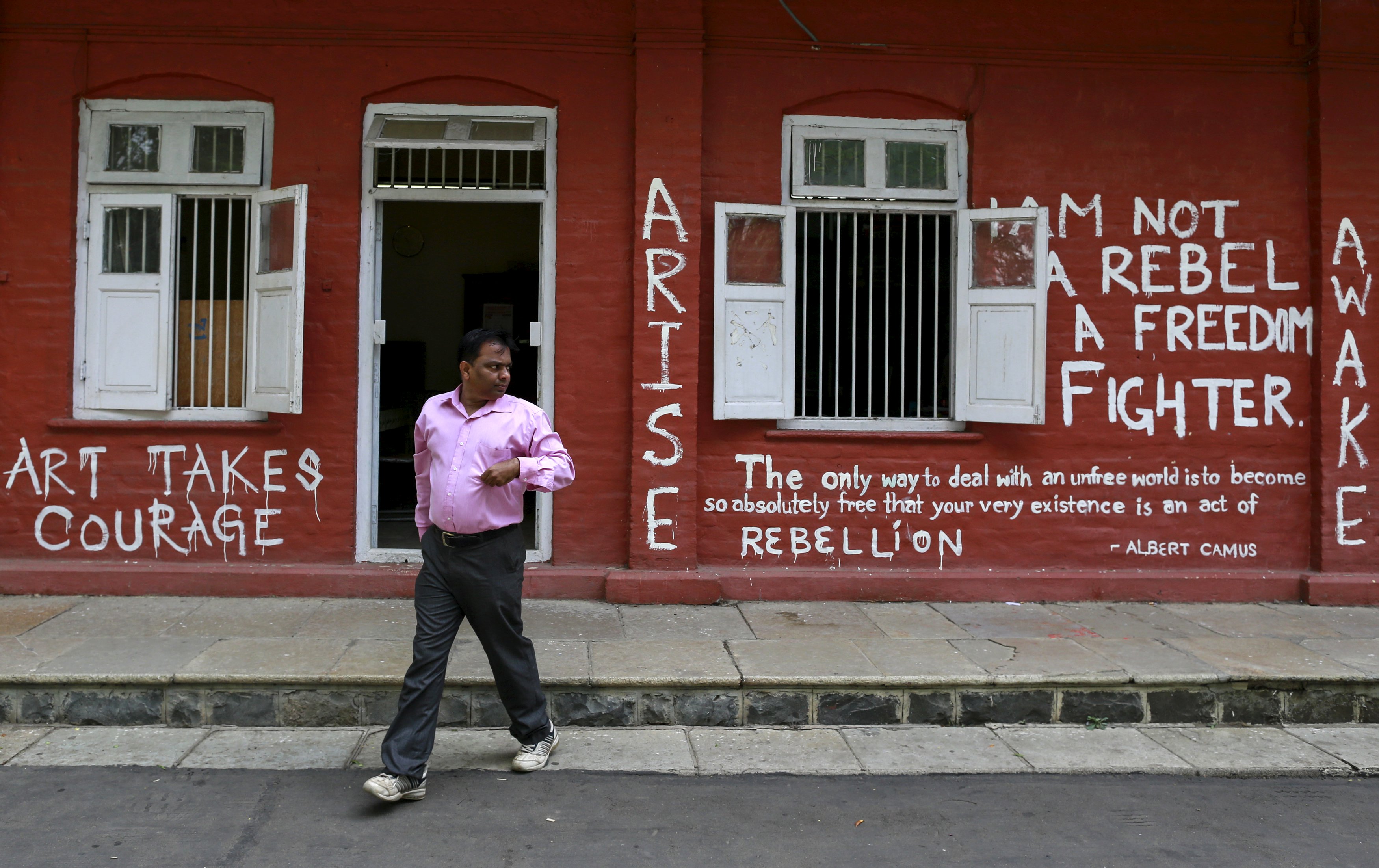 A staff member walks past a graffiti-painted wall of an administrative office at the Film and Television Institute of India  in Pune. Photo: Reuters