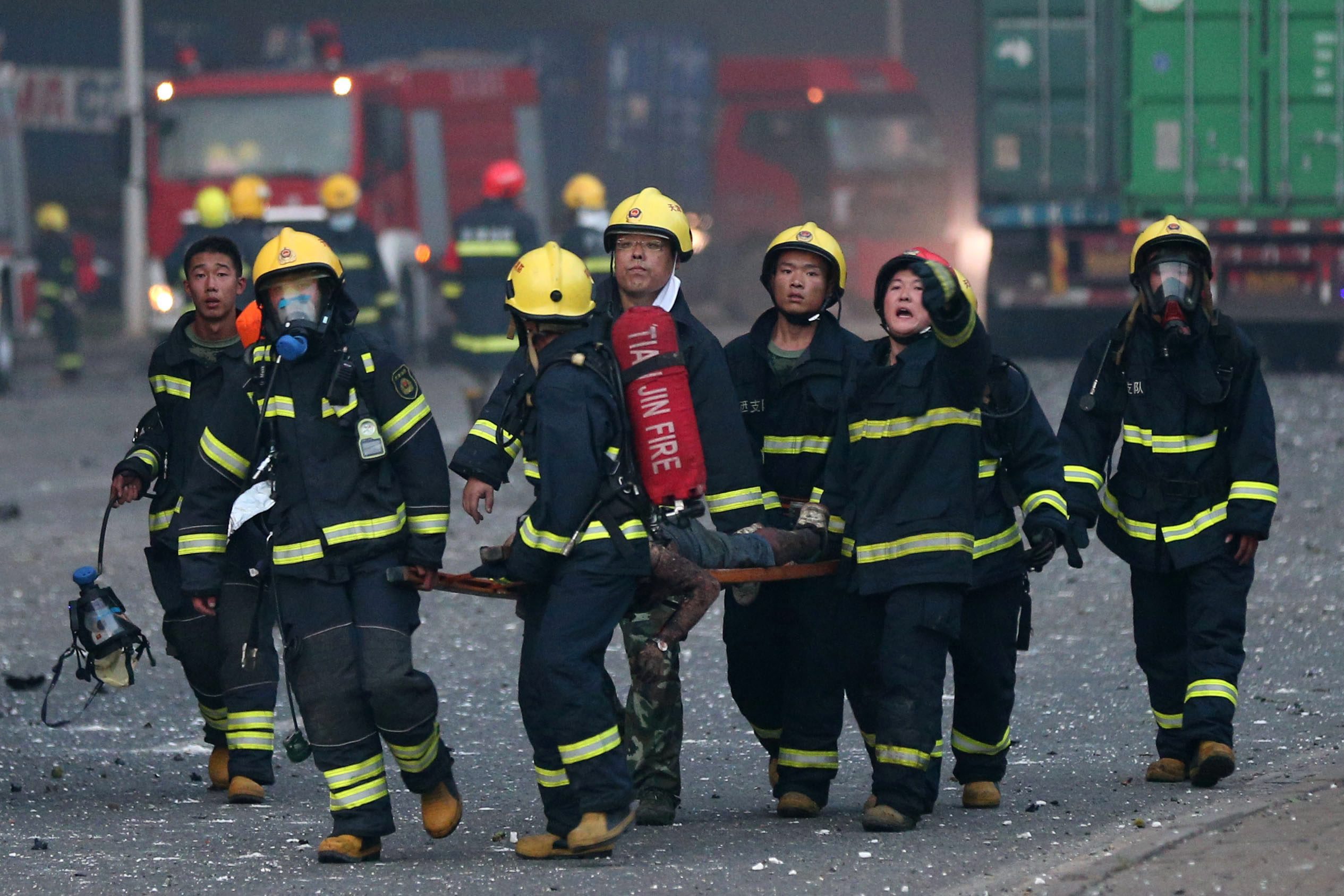 Firemen carry a body found after a huge explosion rocked the port city of Tianjin. Photo: EPA