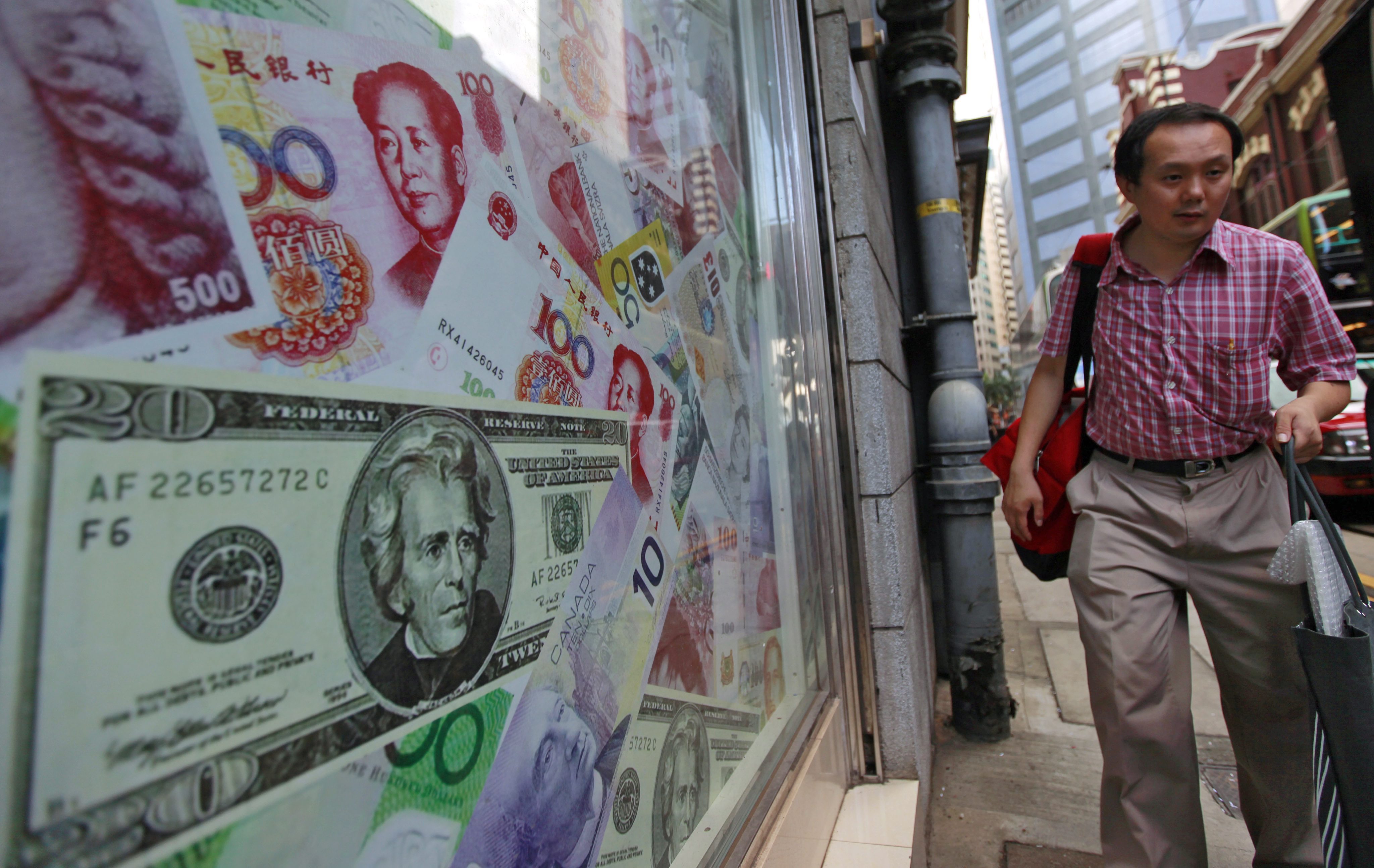 The chinese yuan and the US dollar are seen at a foreign exchange dealer in Hong Kong as Beijing's foreign exchange reserves are seen falling in August in its attempt to prop up the currency. Photo: EPA  