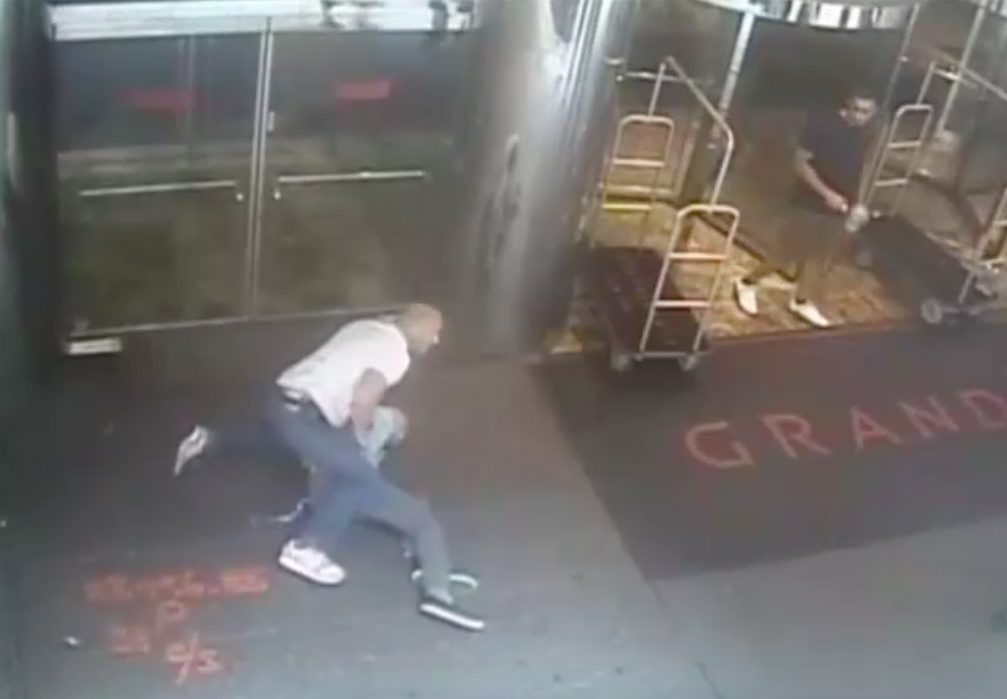 A frame grab from a surveillance video shows an undercover New York City police officer arresting former tennis pro James Blake in front of a hotel in New York. Blake was waiting to attend the US Open. Photo: EPA 
