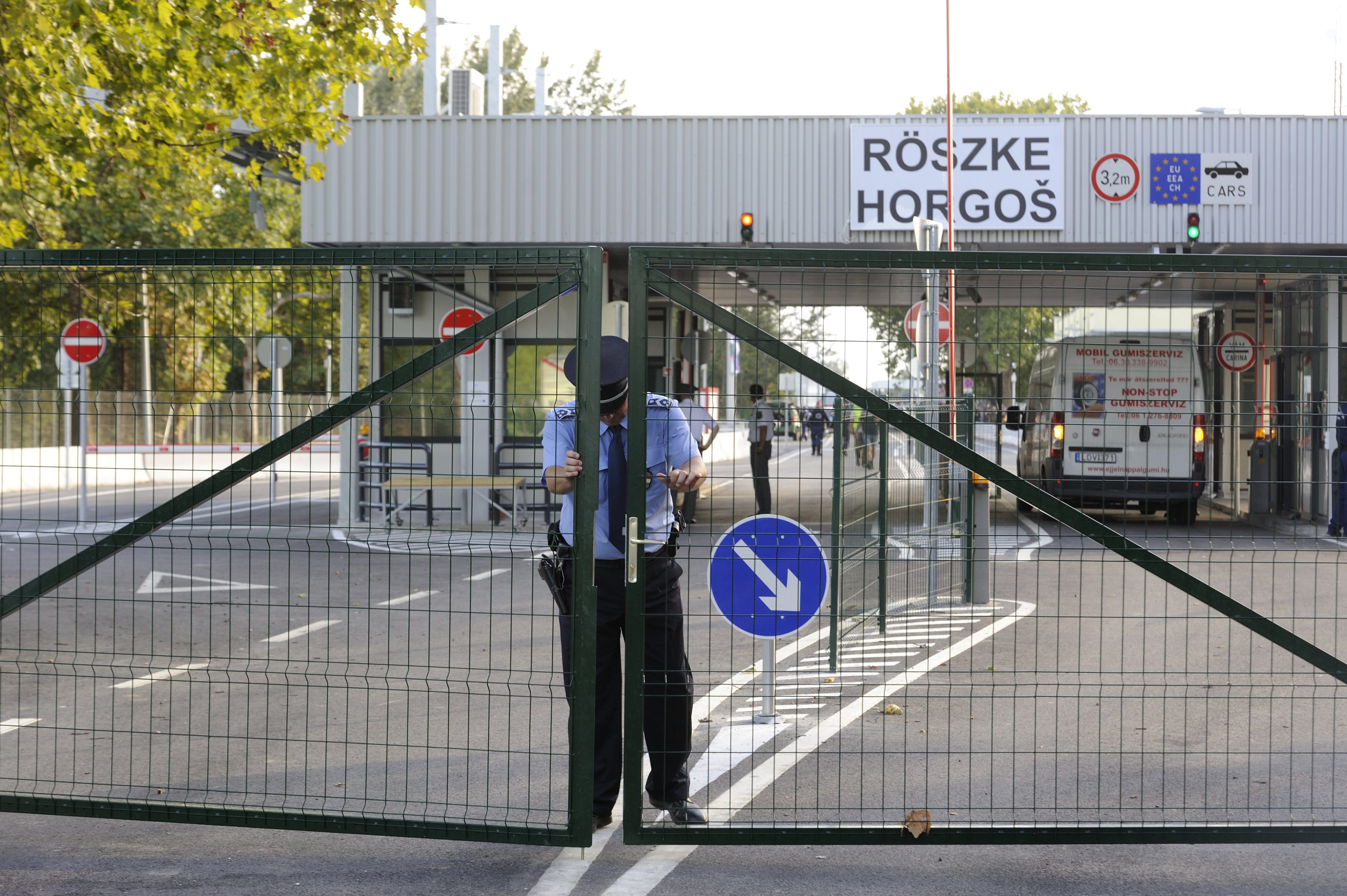 A Hungarian policeman closes the gate of the Horgos-Roszke border crossing with Serbia on Monday. Photo: EPA