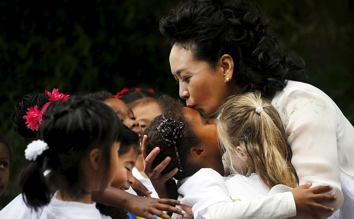 Peng kisses a girl from Washington's Yu Ying Public Charter School. Photo: Reuters