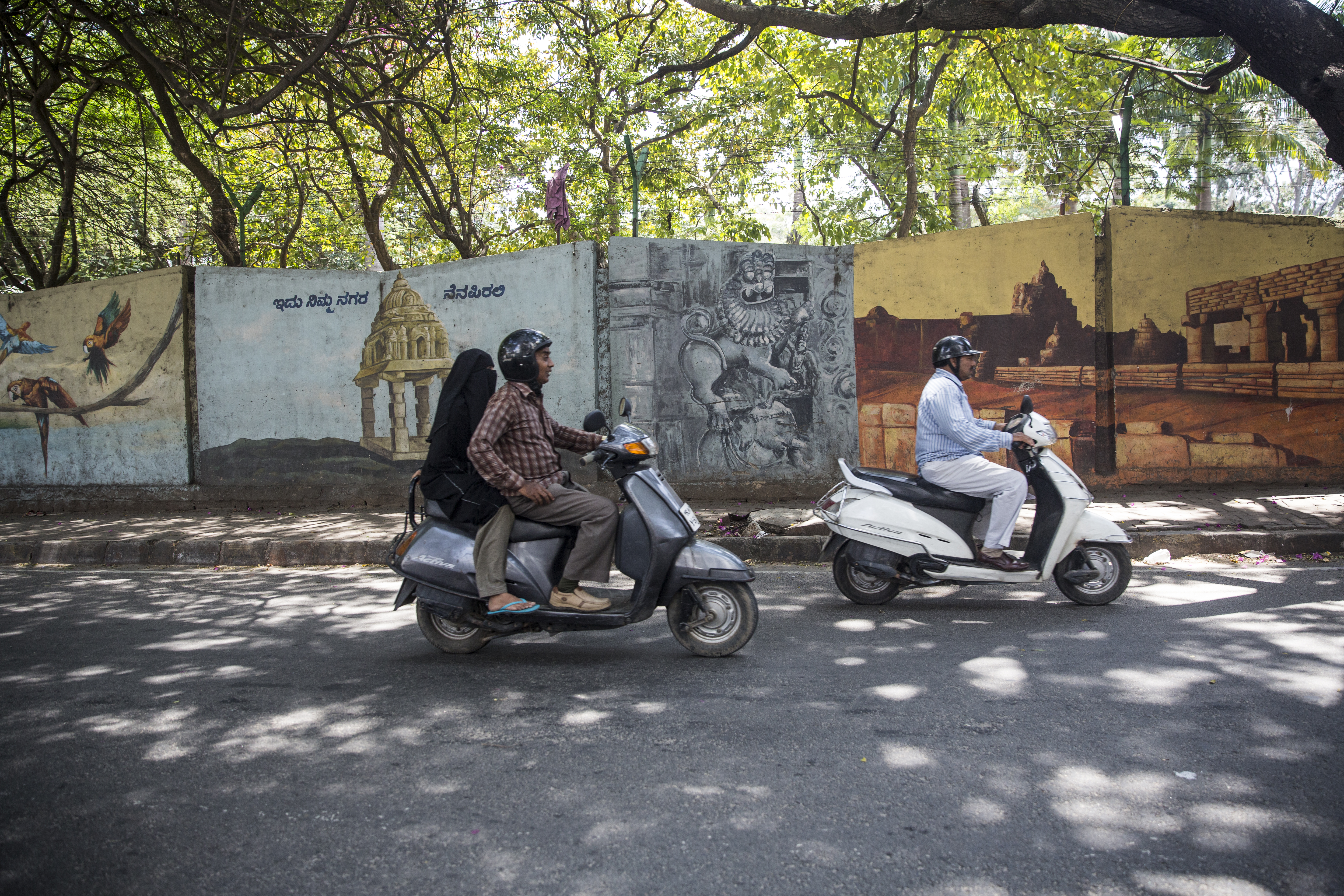 Scooter riders pass street art in Bangalore, India. Photos: Ekaterina Zhilina