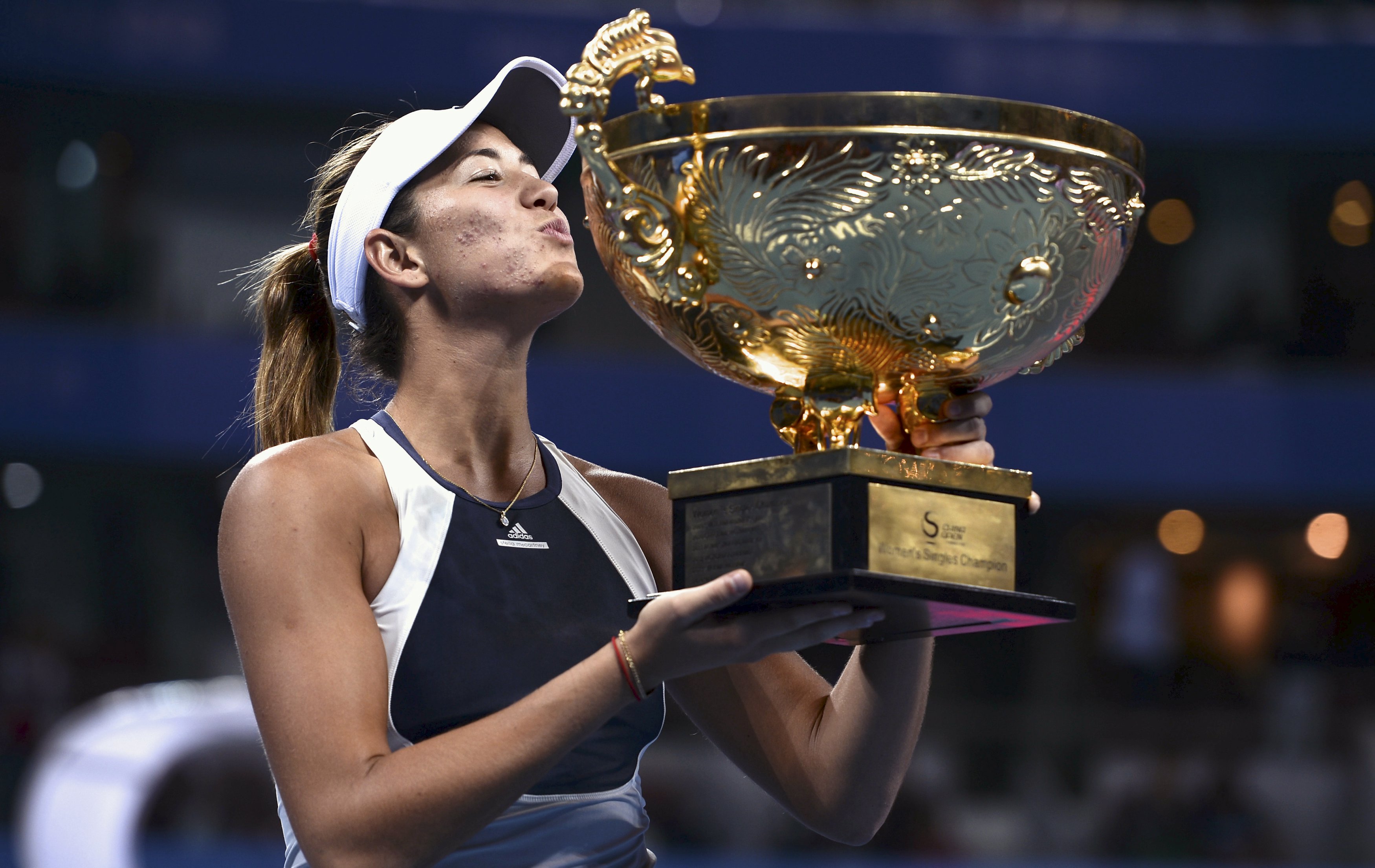 Spain's Garbine Muguruza kisses the winning trophy after her China Open title win in Beijing on Sunday. Hours later she pulled out of Hong Kong. Photo: Reuters