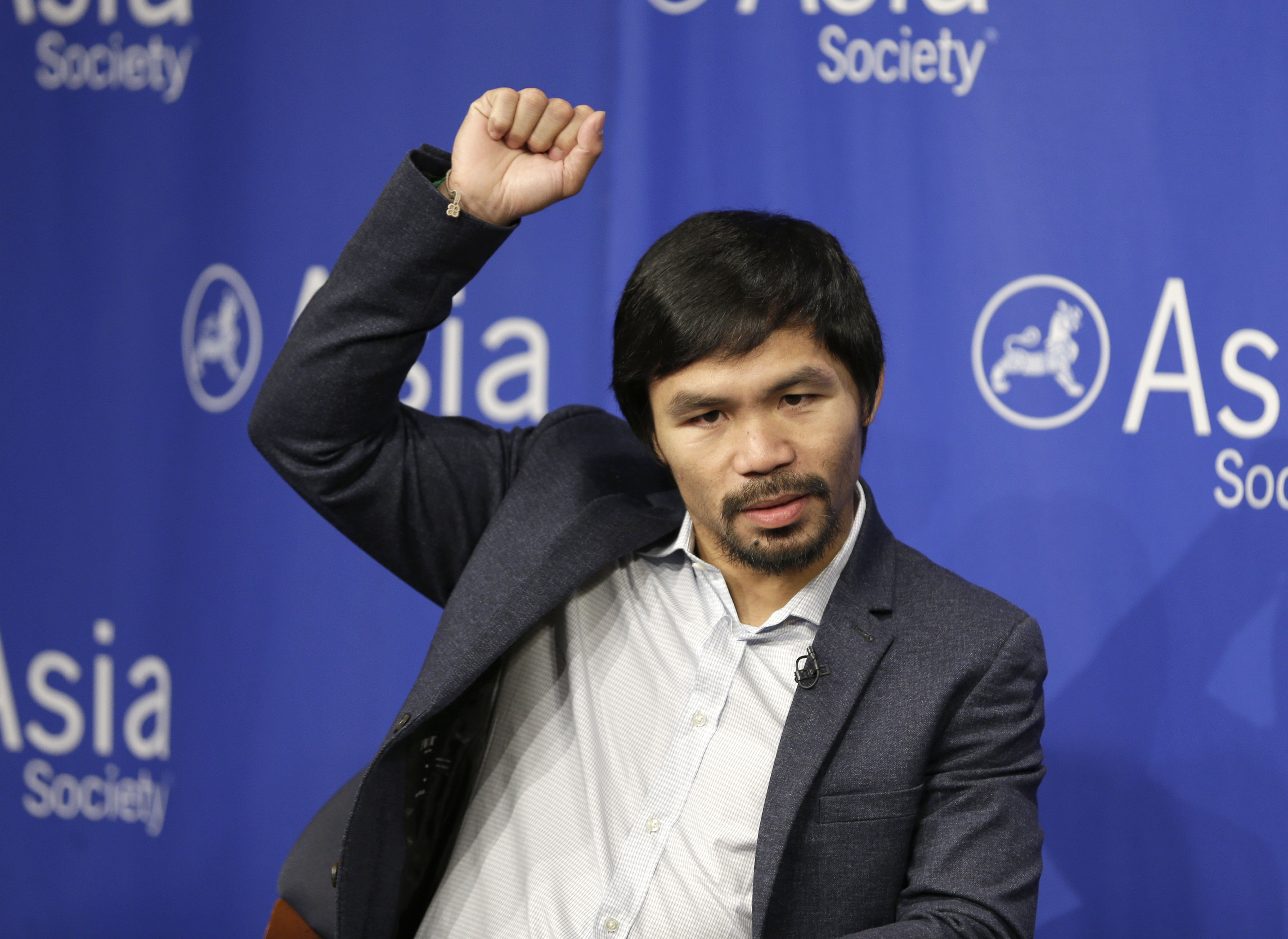 Manny Pacquiao demonstrates the extent to which his surgically repaired shoulder has healed. Photo: AP