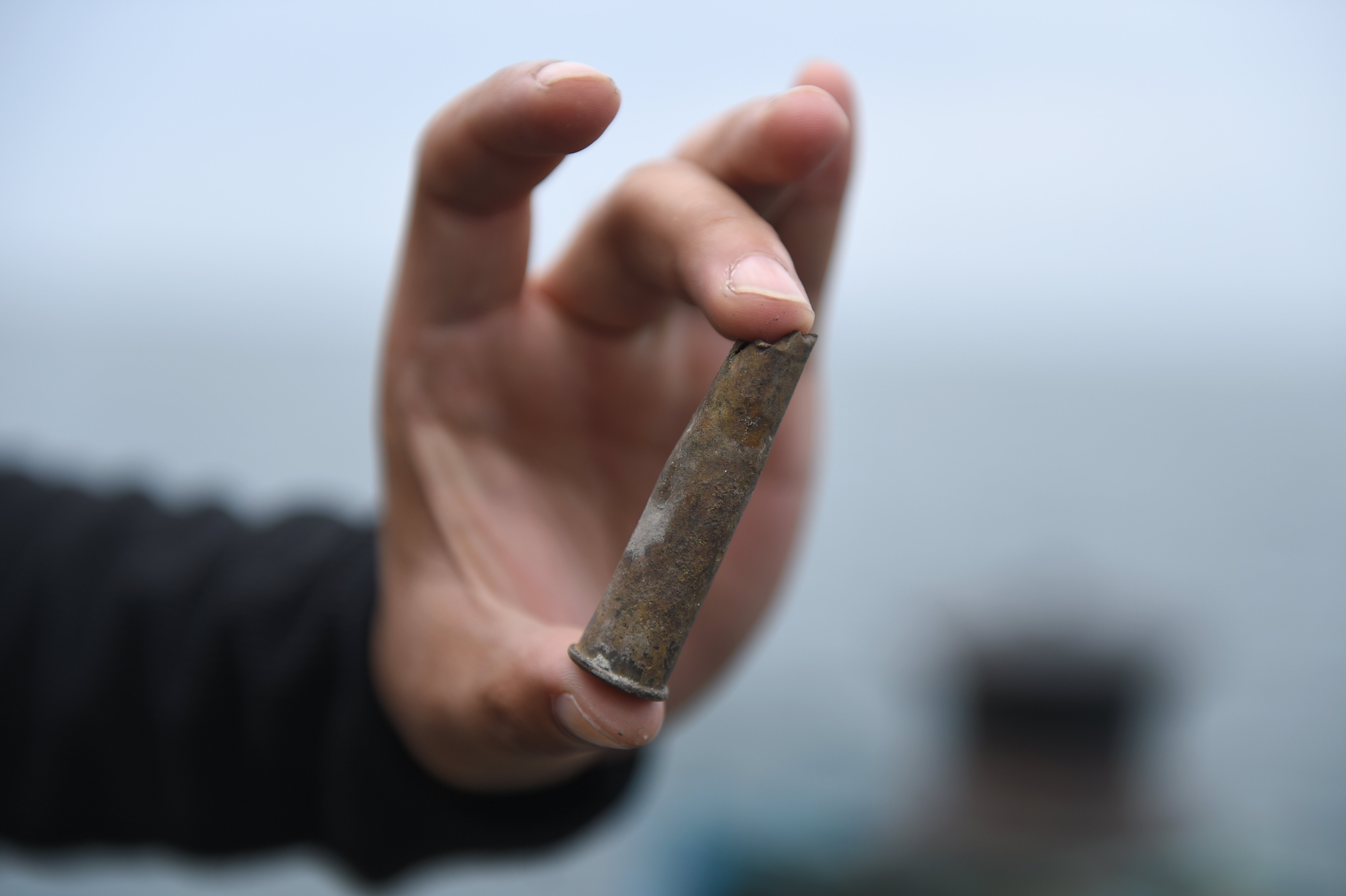 A worker displays an item salvaged from the Qing-era warship. Photo: Xinhua