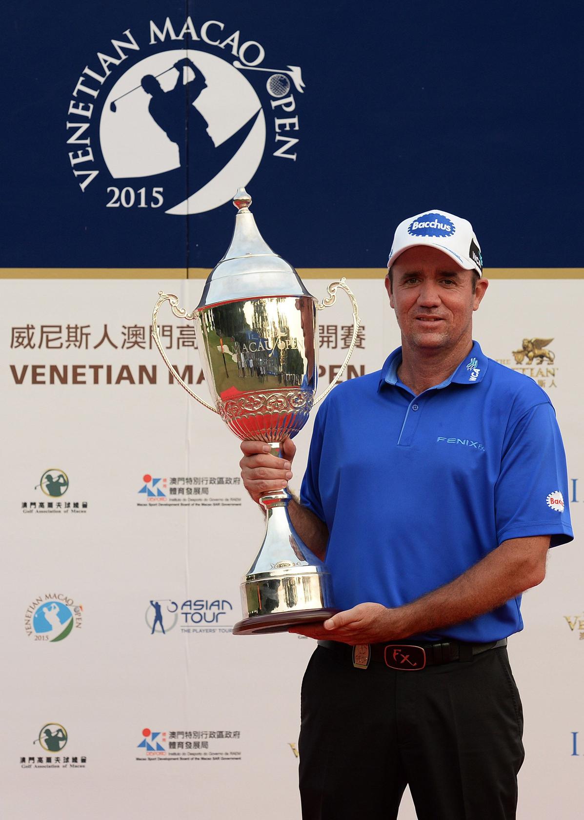 Scott Hend, 42, is all smiles as he clutches the Venetian Macao Open trophy after carding a tournament record 20-under par 264. Photo: AFP    