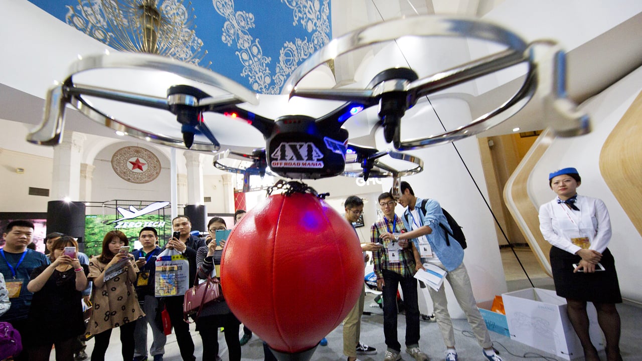 Visitors to the China Hobby Expo watch a drone controlled by a mobile phone fly in Beijing. Unmanned and remote-controlled aerial vehicles are gaining in popularity as prices drop and capabilities grow. Photo: AP