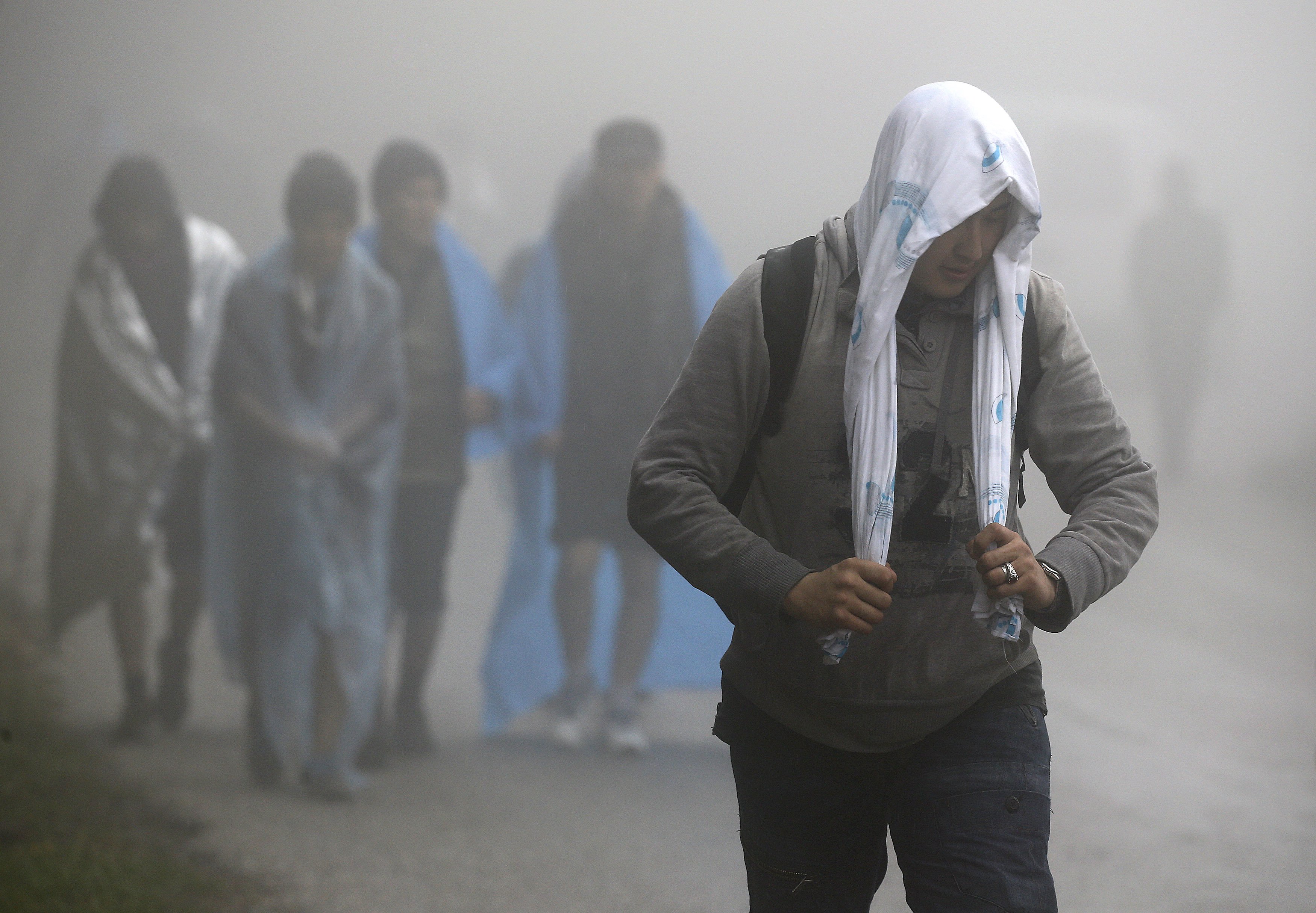 Afghan migrants walk through rain and fog on their way to the nearest registration camp on the Greek island of Lesbos. The world is, once again, in a time of great turbulence, transition and opportunity. Photo: Reuters