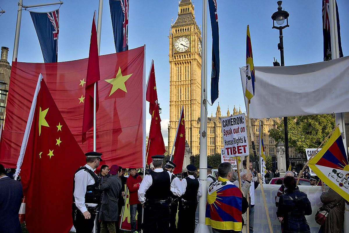 Protester and supporters of Chinese President Xi Jinping gathered outside the Houses of Parliament on Tuesday. Photo: AP