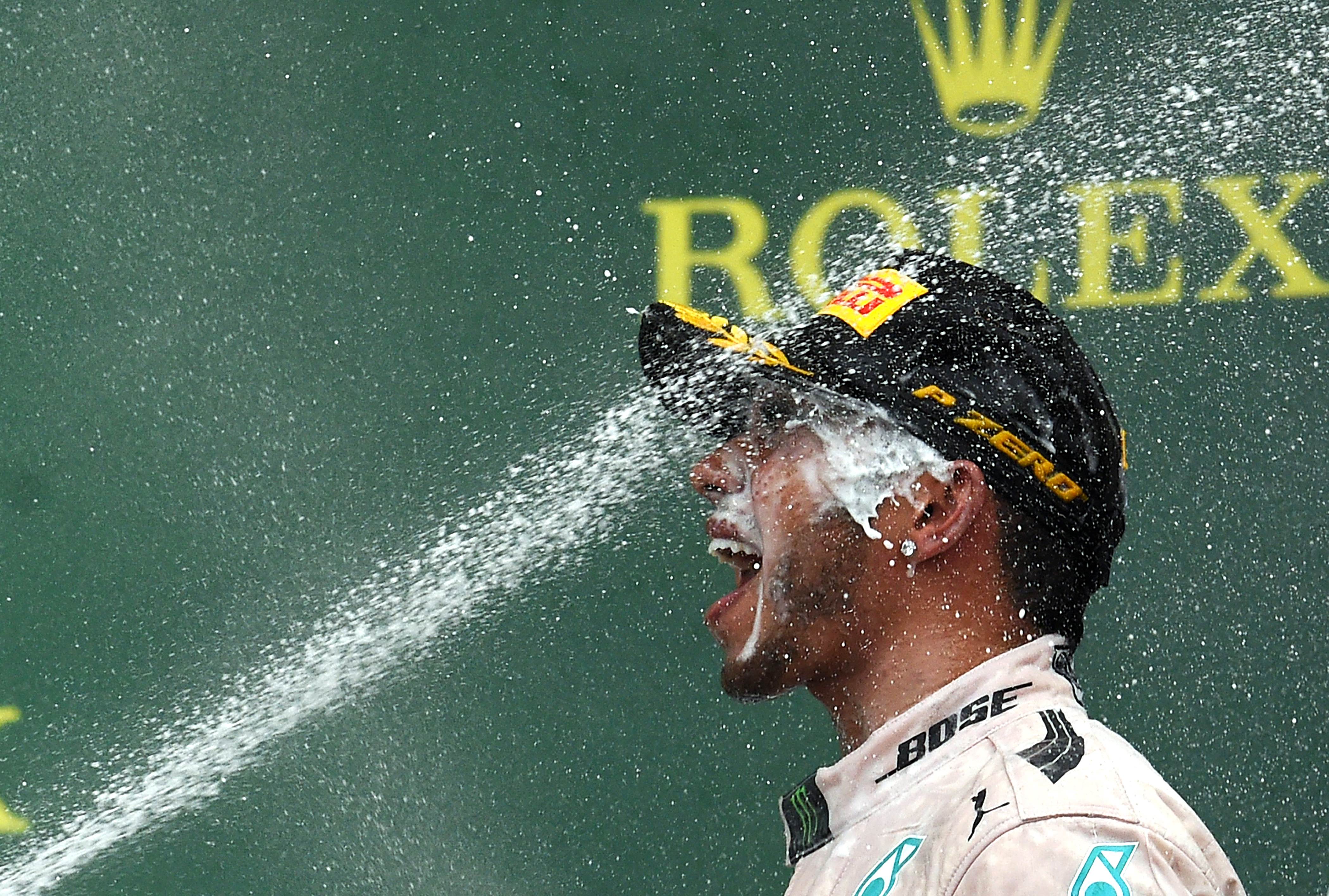 Mercedes driver Lewis Hamilton celebrates is saoked on champagne on the podium after winning the US Formula One Grand Prix at the Circuit of The Americas in Austin, Texas.  Photo: AFP