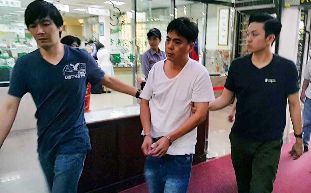 One of the two suspects in Hong Kong businessman Taiwan kidnap case brought to police station. Photo: SCMP Pictures