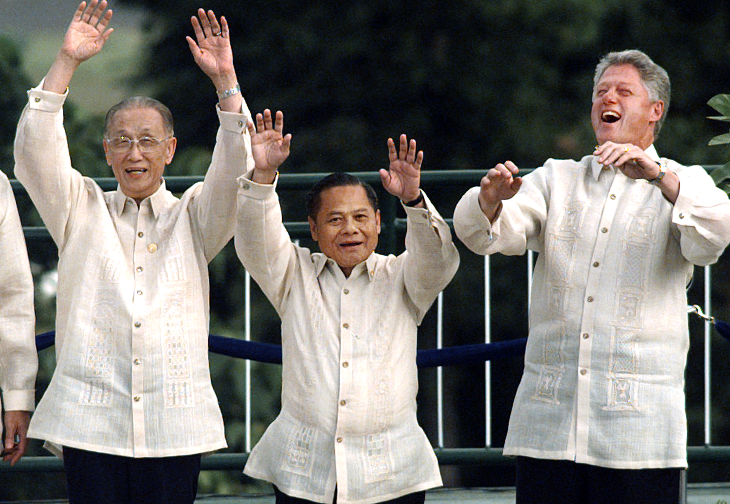 1996, Subic Bay, the Philippines: US President Bill Clinton, right, wearing a traditional “barong tagalog”, does “the wave” with Koo Chen-fu of Taiwan, left, and Thai Prime Minister Banharn Silpa-archa. Photo: AP
