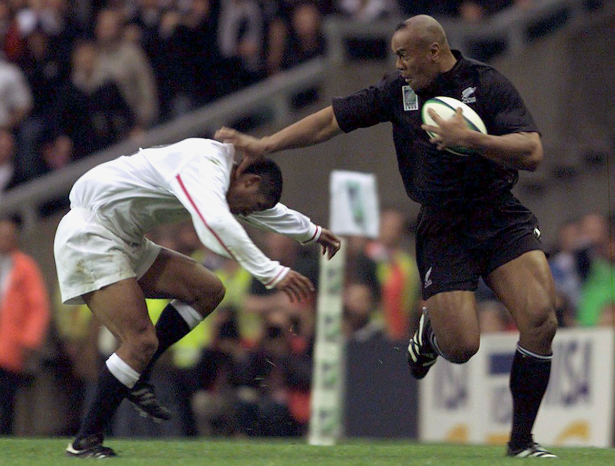 New Zealand's Jonah Lomu pushes off Jeremy Guscott of England during their 1999 Rugby World Cup match at Twickenham. The All Blacks great, who revolutionised wing play to become rugby union's first global superstar, died in Auckland on November 18, 2015 at the age of 40. Photo: Reuters