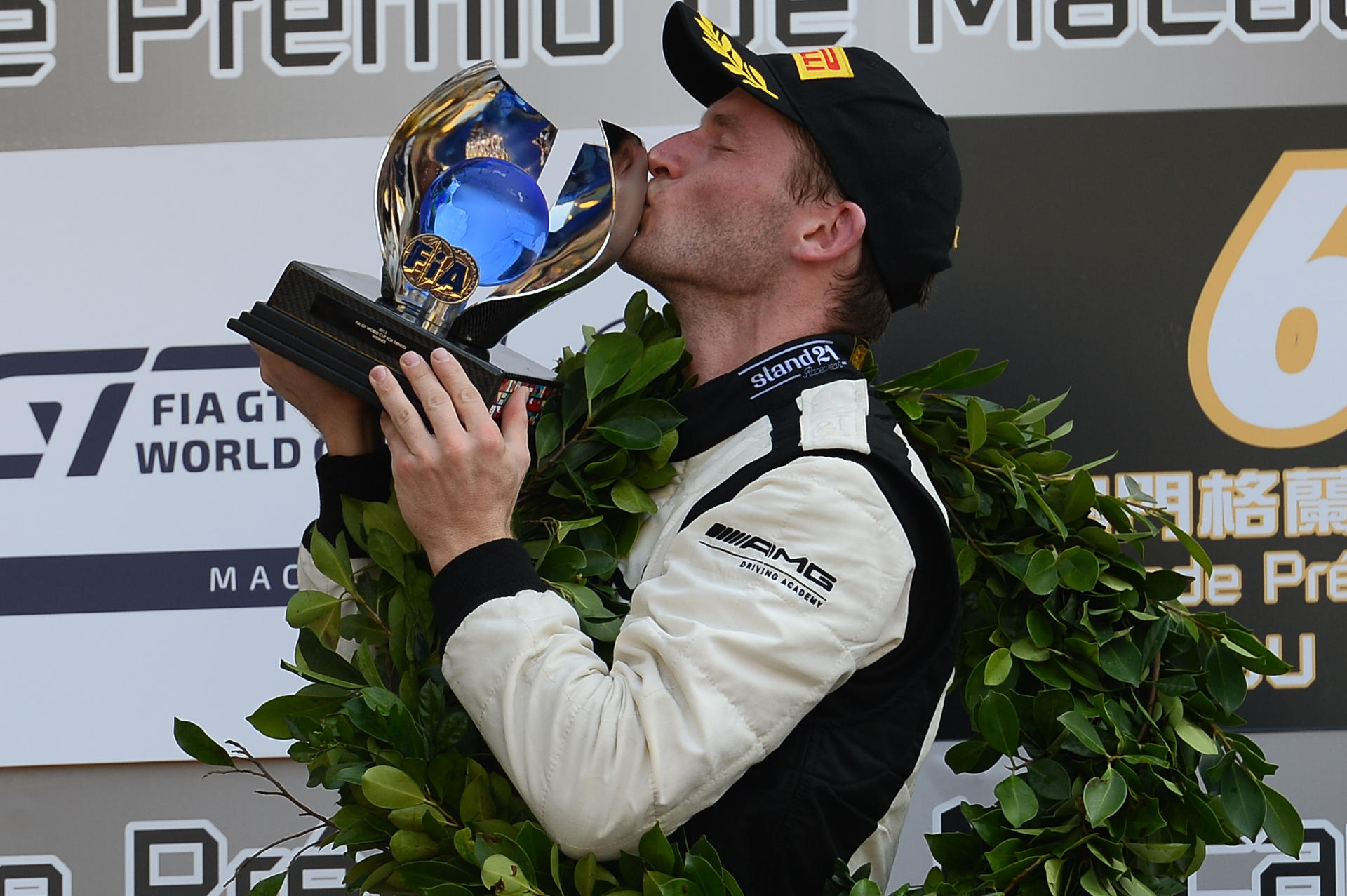 Maro Engel kisses the trophy after his win. Photo: Xinhua