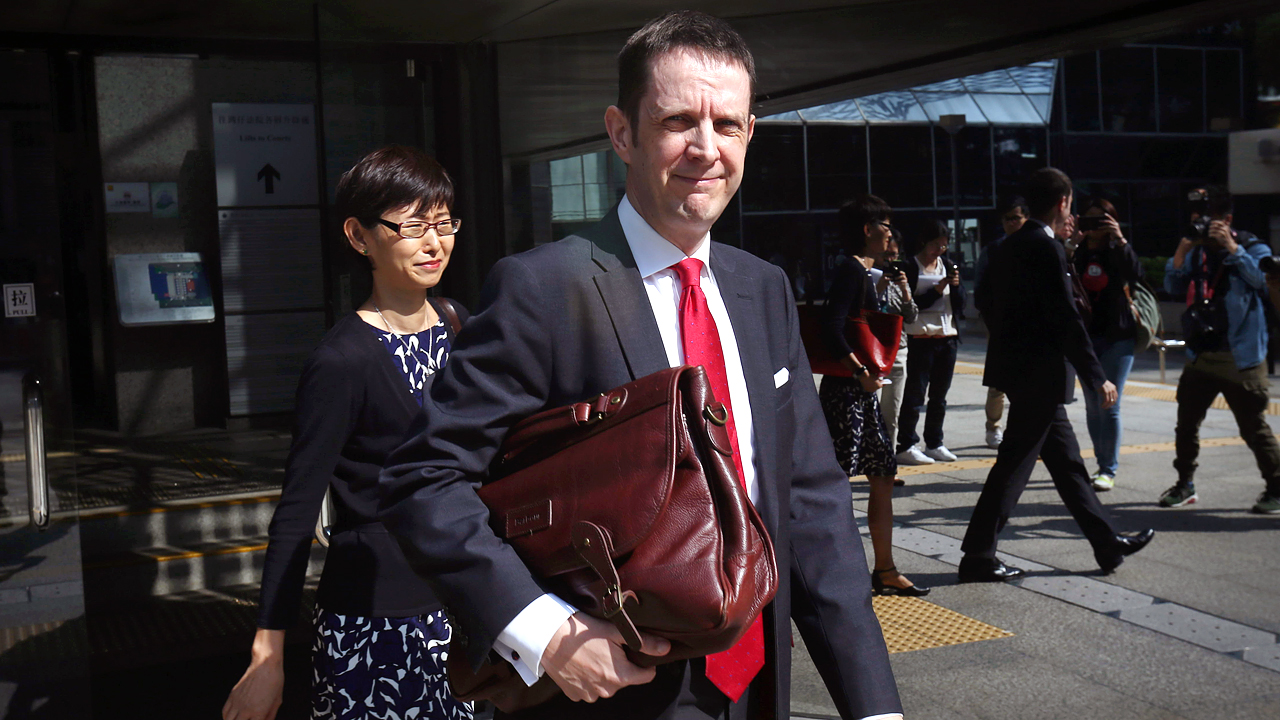 Mark McFarland with his wife Irene Li appears at the Small Claims Tribunal in Wan Chai. Photo: SCMP Pictures