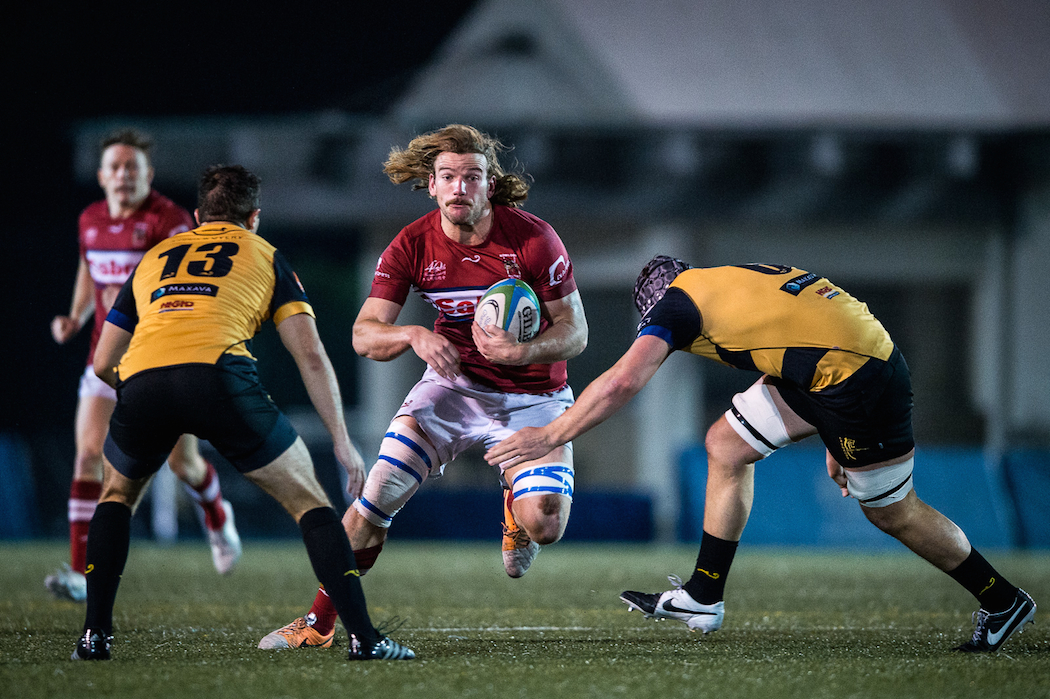 Kowloon and Hong Kong flanker James Cunningham spots a gap in the Tigers defence. Photos: HKRU