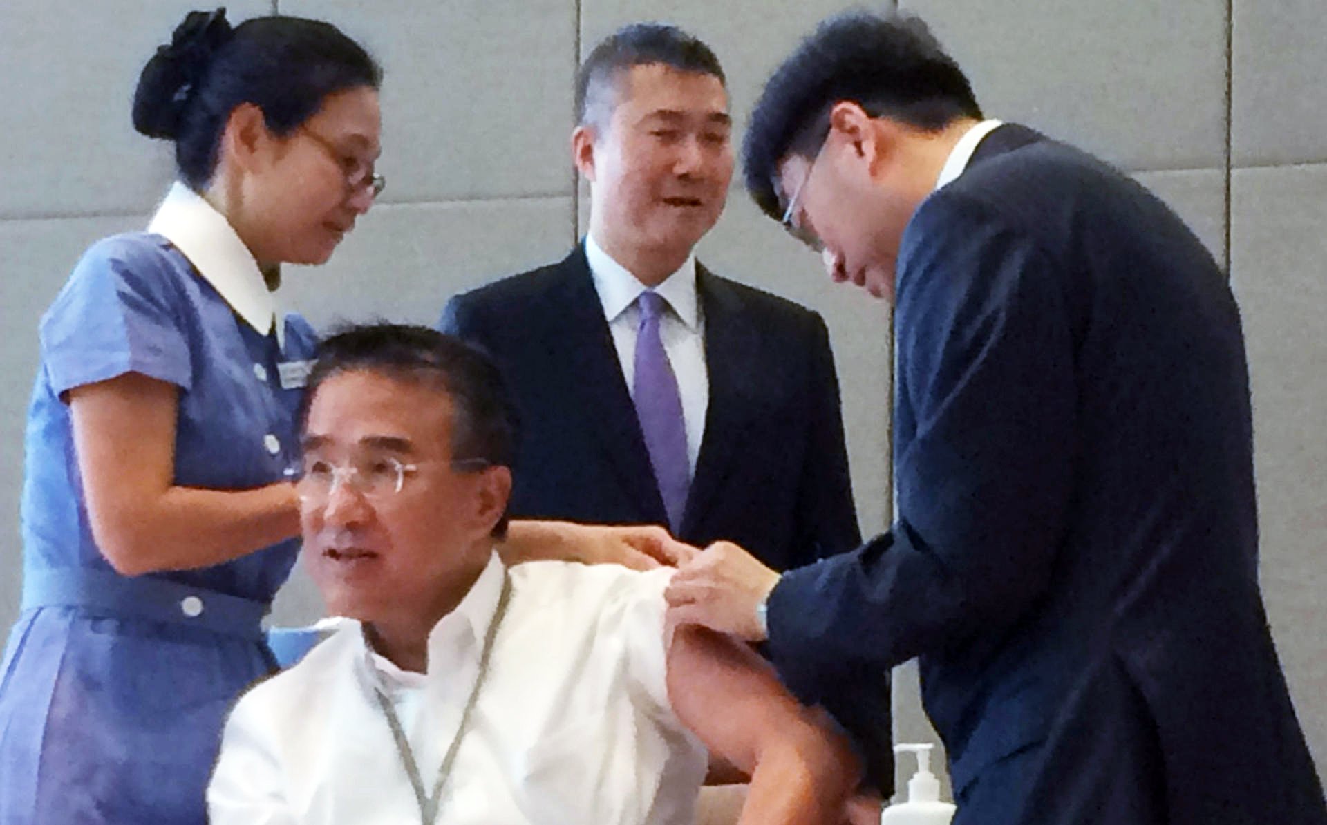 Dr Ko Wing-man gives Michael Tien a flu jab. Photo: Jeffie Lam