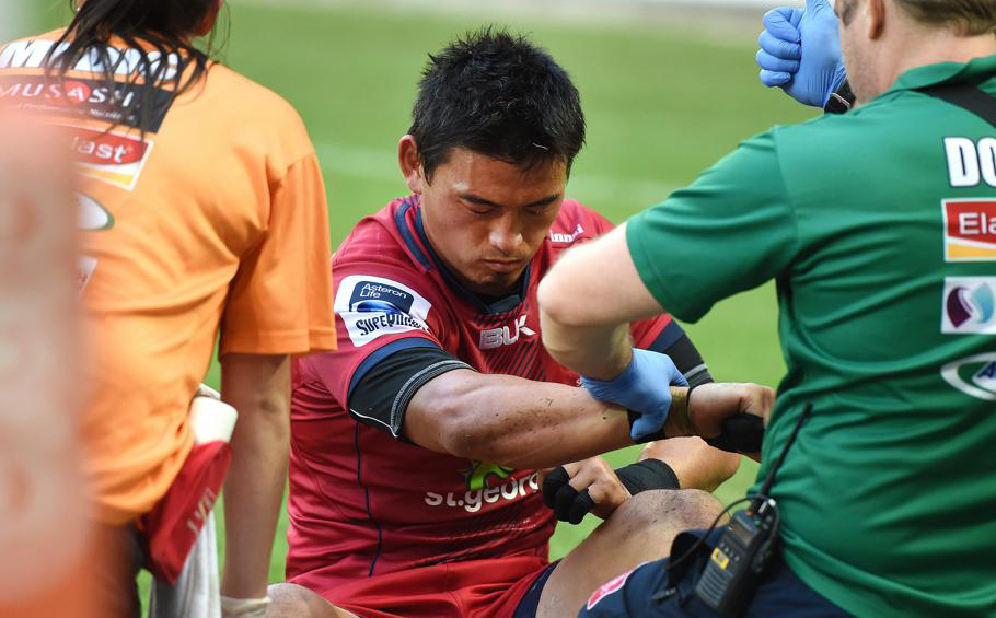Fullback Ayumu Goromaru is attended to by medical staff before going off injured midway through the second half of the Reds’ 35-25 Super Rugby victory over the Sunwolves on Saturday. Photo: EPA