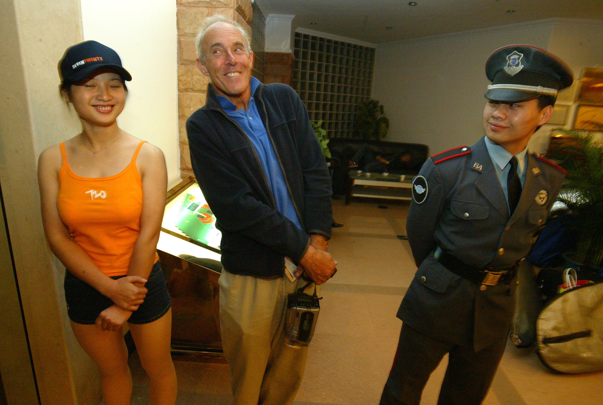 Surf competitor John Haynes jokes with the 720 China Surf Open promotion girl in the hotel in Shanwei during the 720 surfing competition in Cherry Point, Shanwei, China. Photo: Antony Dickson