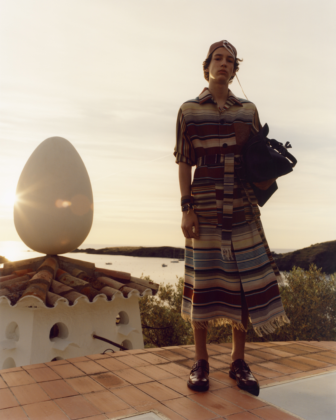 Striking multicolour striped buttoned and belted coat with fringed edges is the season’s must-have.