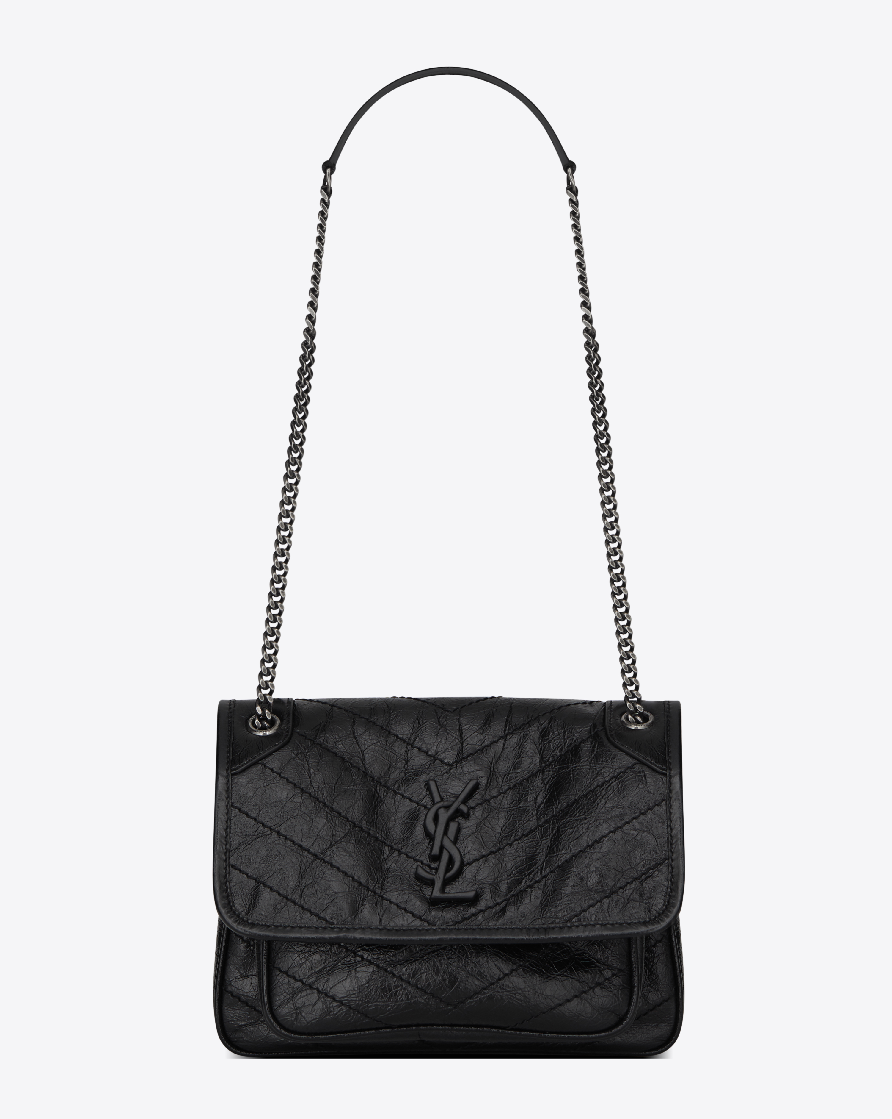 Baby Niki chain bag in black textured quilted leather.
