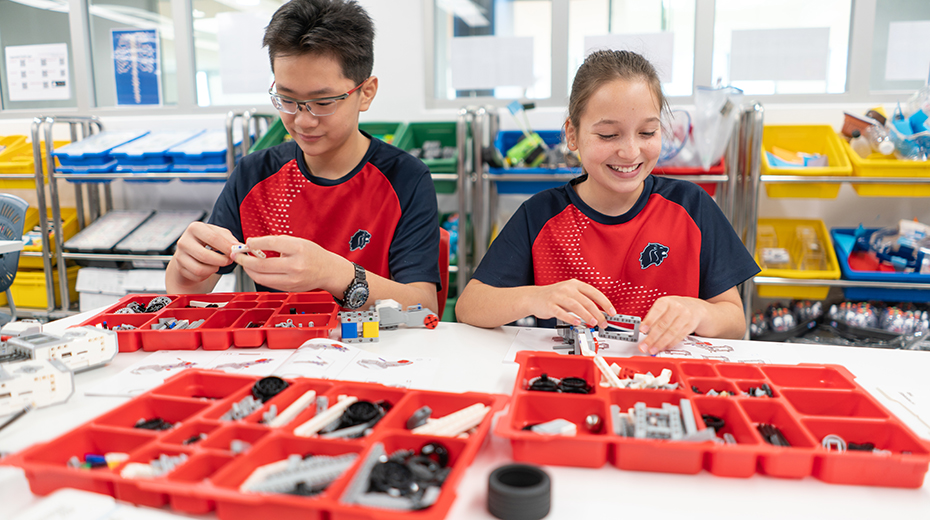 Middle School students at Stamford American School working with robotics in the Innovation Center