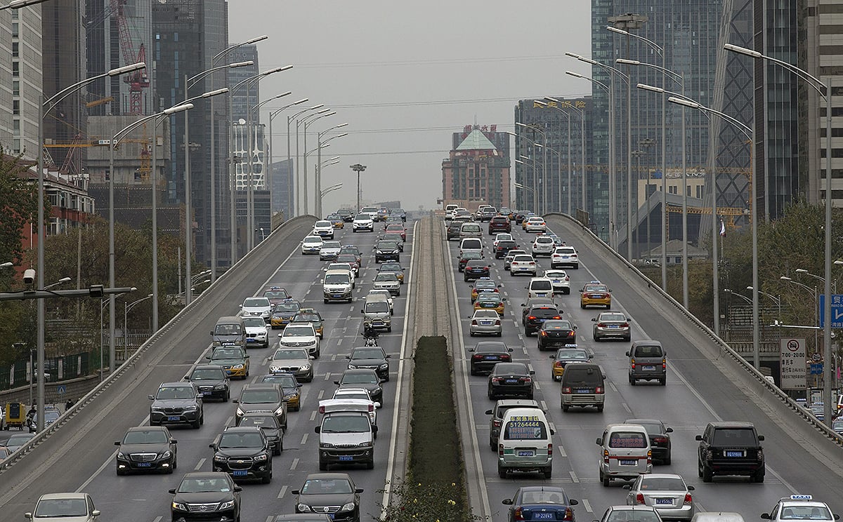 After the Olympics, Beijing implemented a controversial new rule that barred one-fifth of the city's private vehicles from the roads on weekdays, according to the last number on their licence plates. Photo: EPA