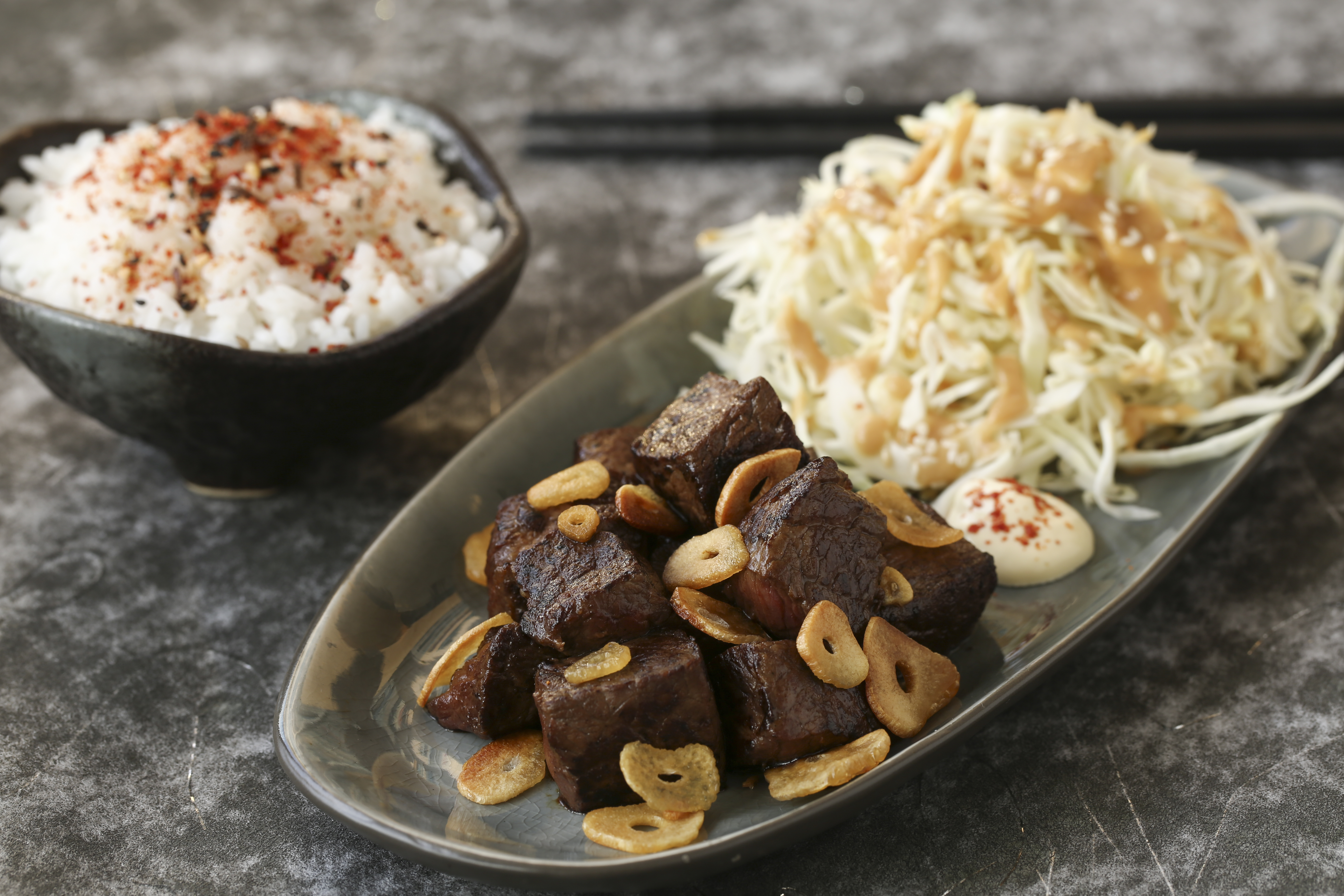 Japanese beef cubes with fried garlic and shredded cabbage