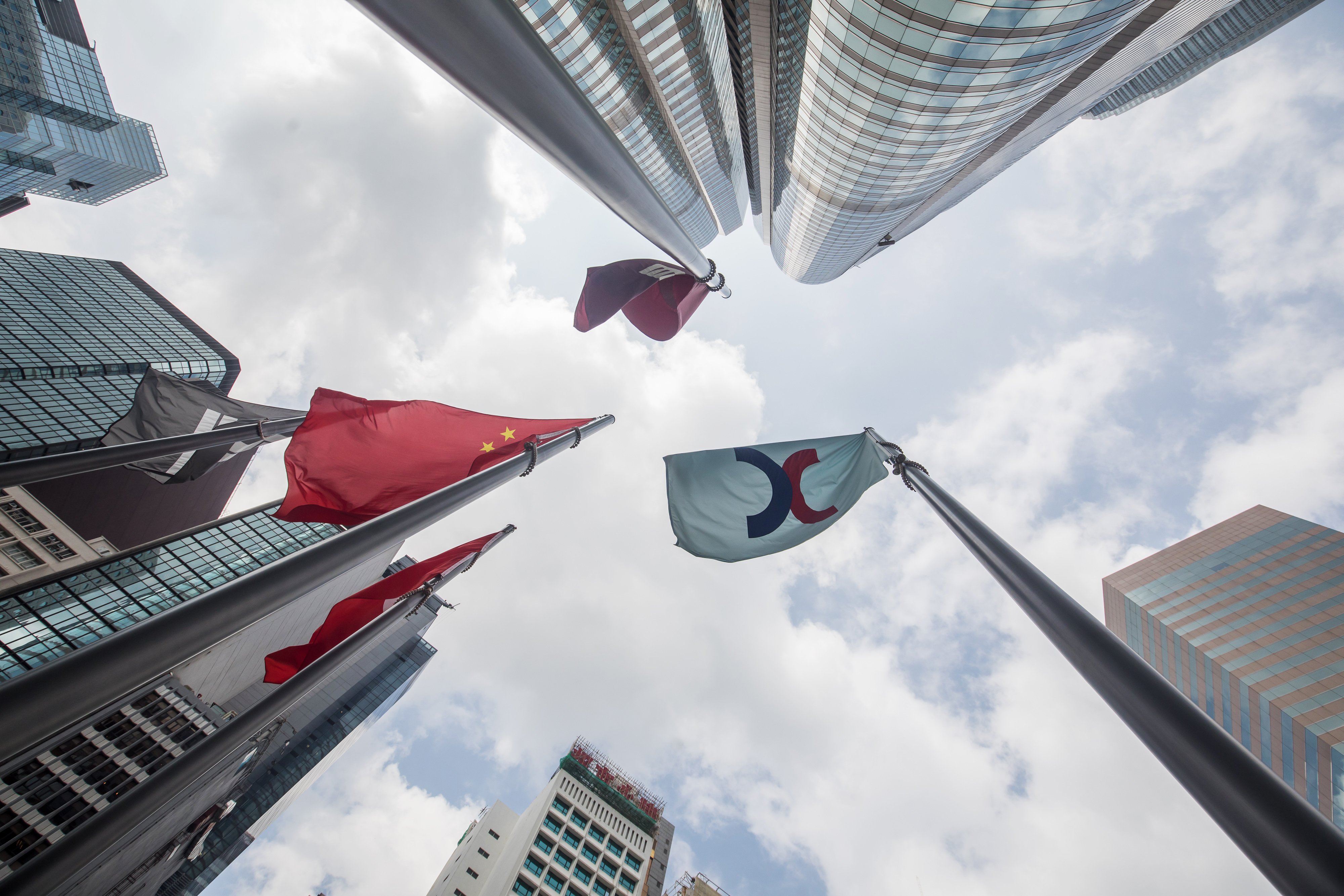 The corporate flag for Hong Kong Exchanges & Clearing (HKEX) and the Chinese flag fly outside the Exchange Square complex in Hong Kong. Photo: Bloomberg