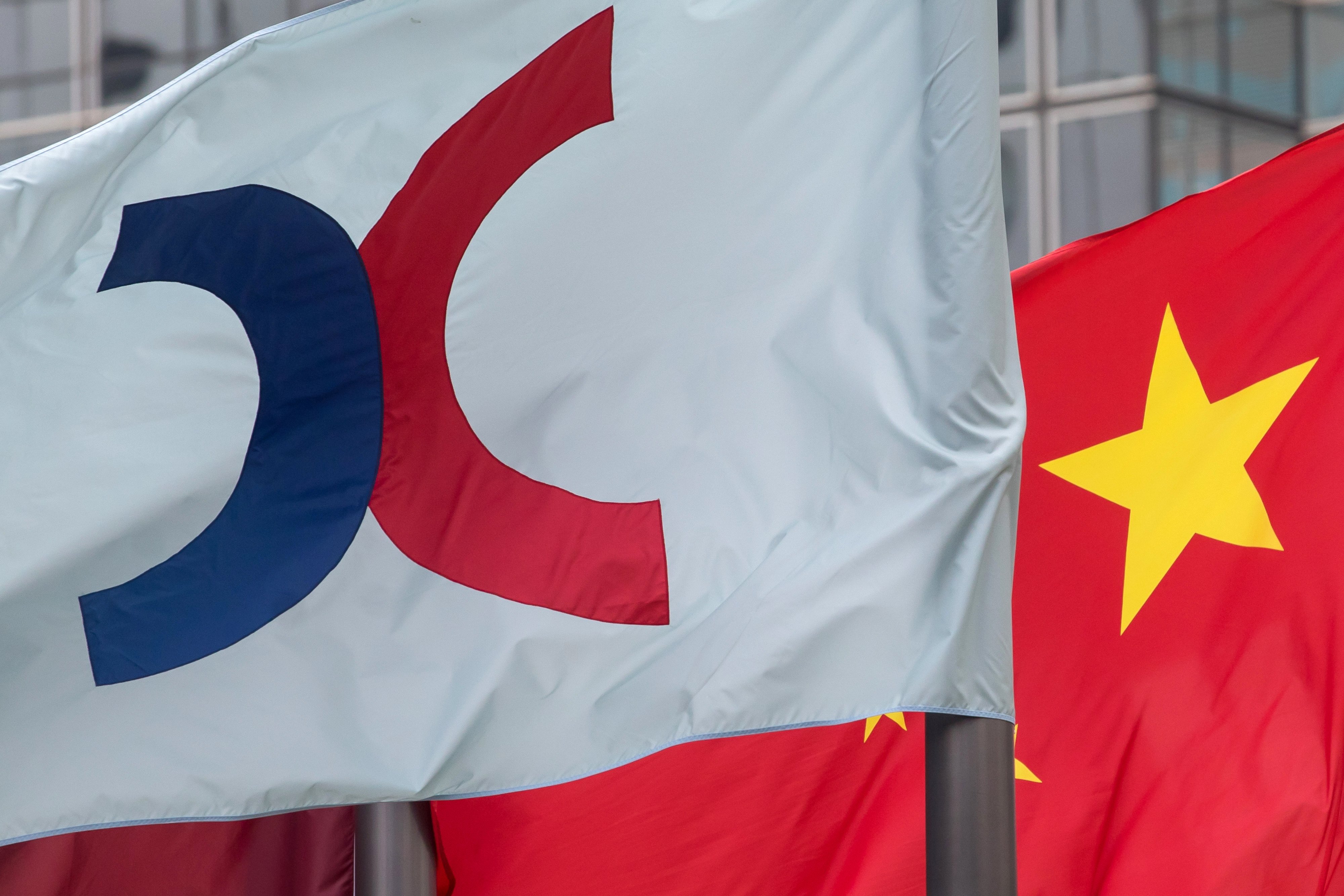The corporate flag for Hong Kong Exchanges & Clearing (HKEX) and the Chinese flag fly outside the Exchange Square complex. Photo: Bloomberg