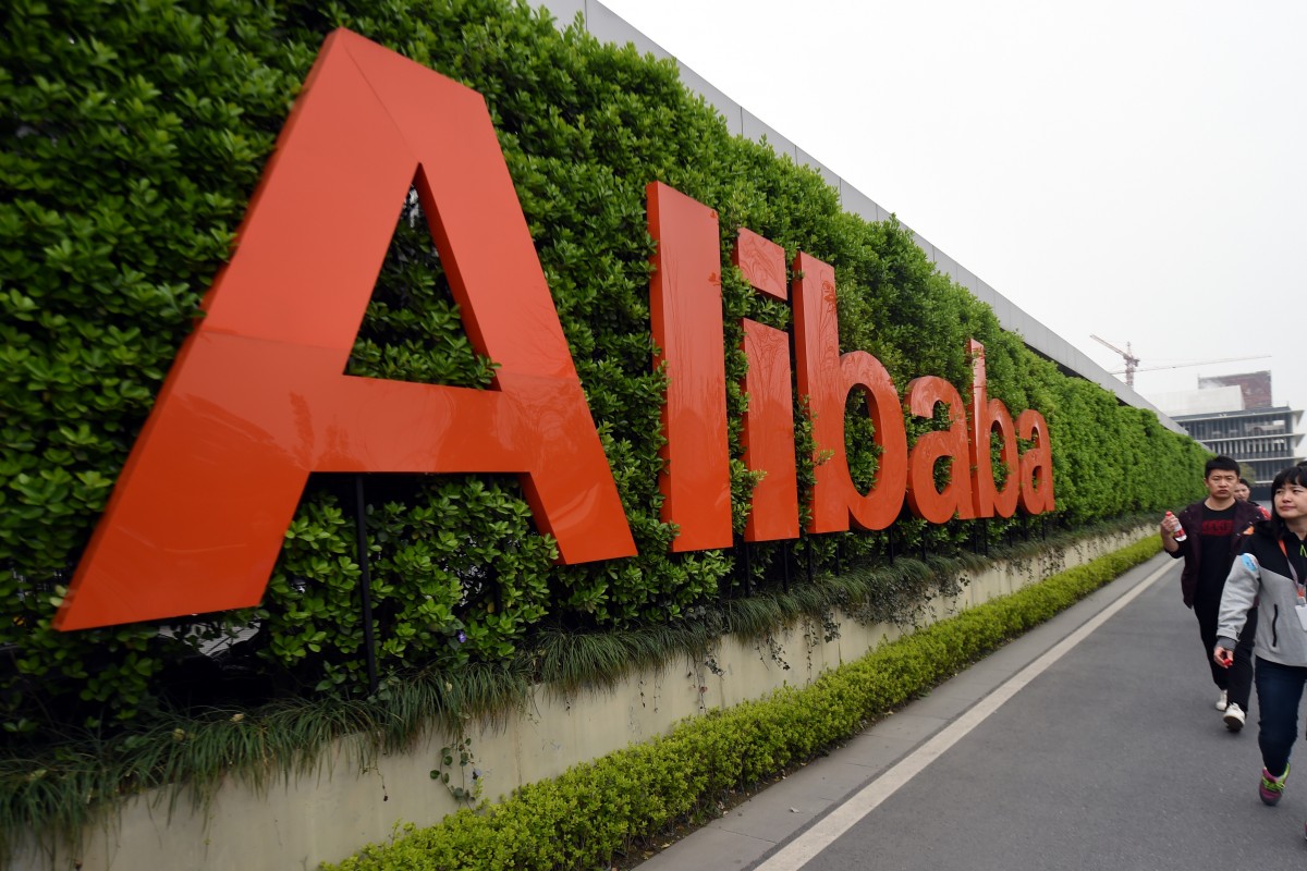 People walk past a logo of China's e-commerce giant Alibaba in Hangzhou, China. Excitement about Alibaba's coming IPO boosted trading sentiment in Hong Kong Tuesday. Photo: Xinhua