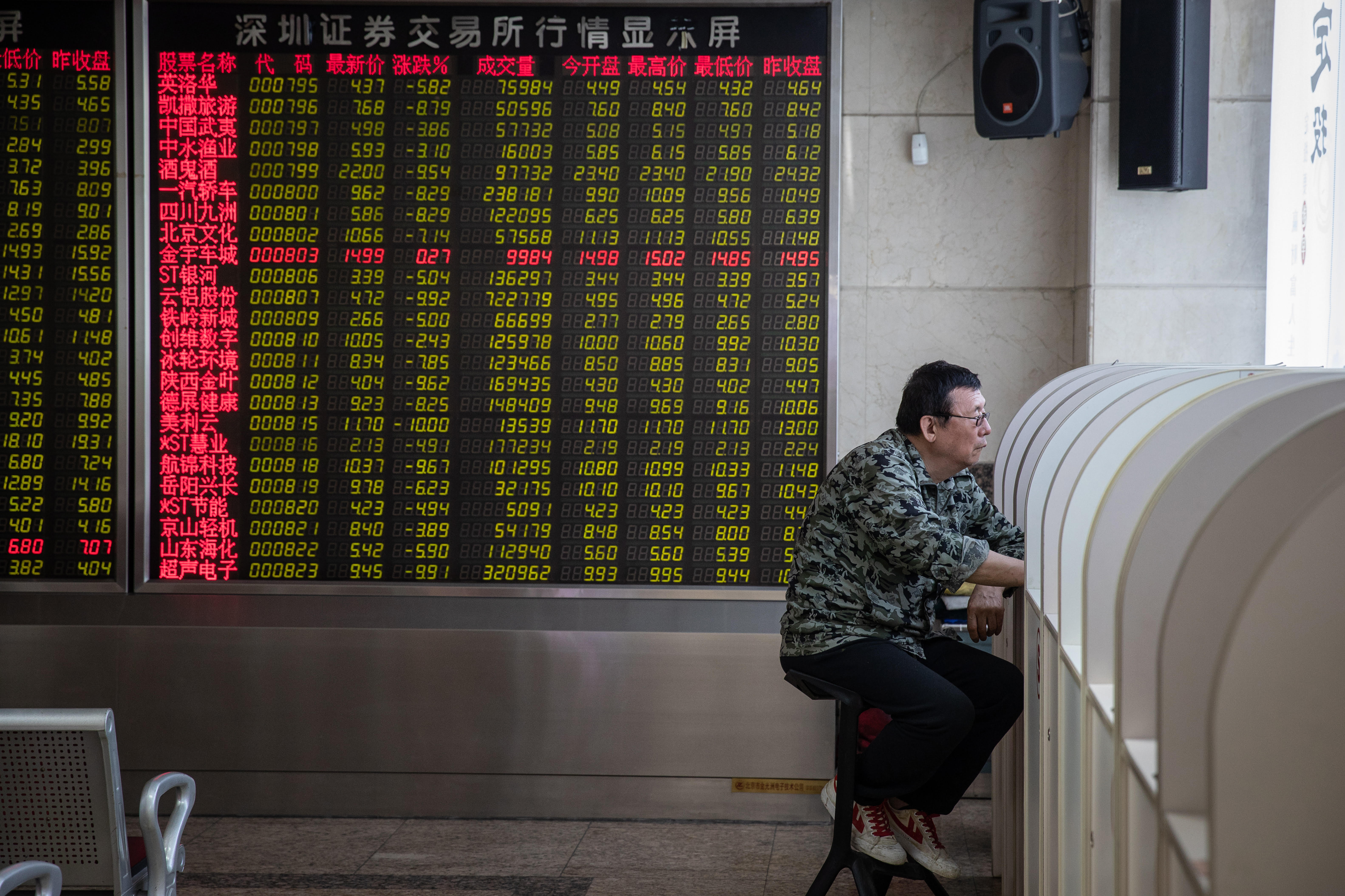 A Chinese investor studies stocks at a brokerage in Beijing. Photo: EPA-EFE
