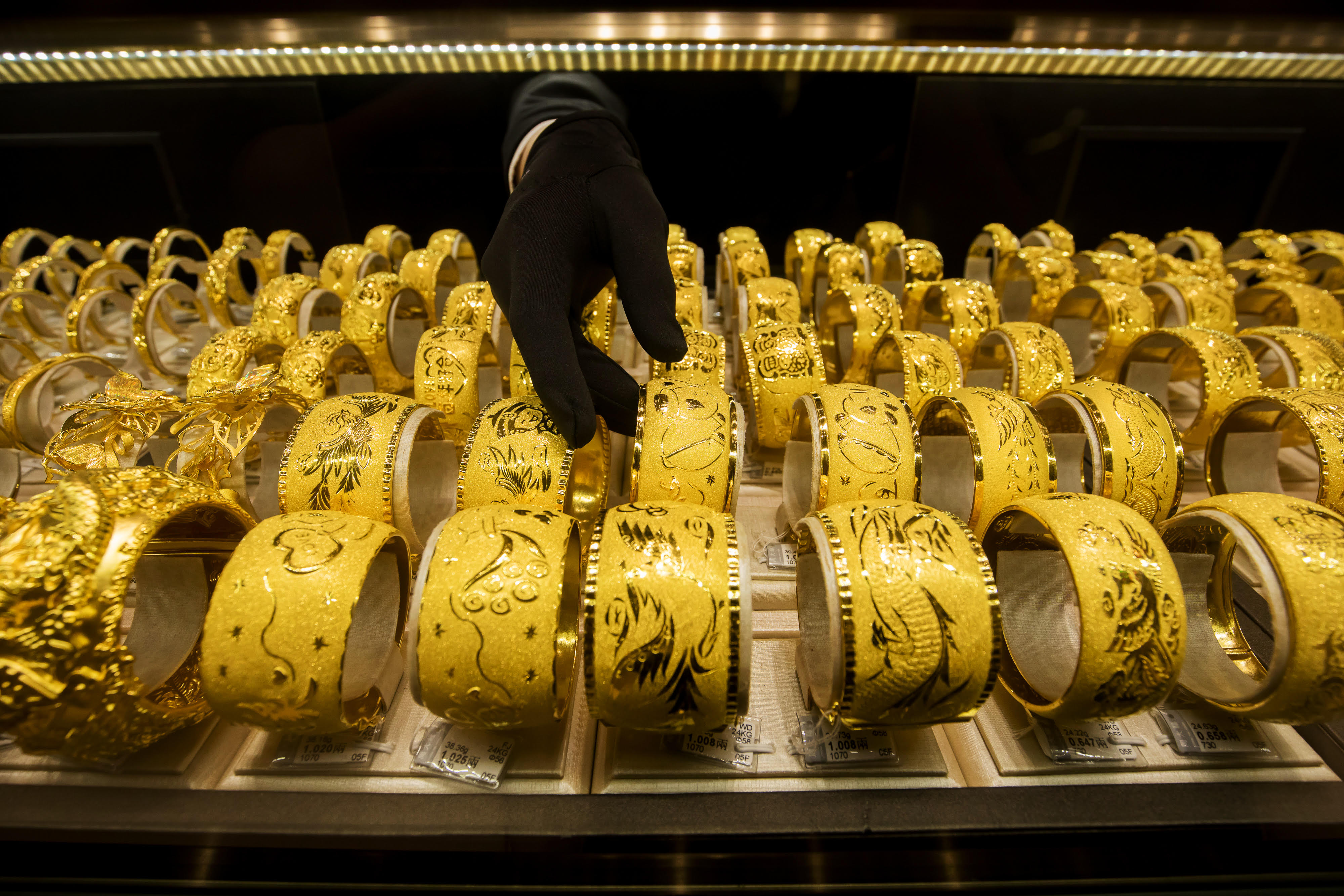 Gold-linked stocks shot up today on growing US-China tensions. Above gold bracelets on display in Hong Kong. Photo: Bloomberg