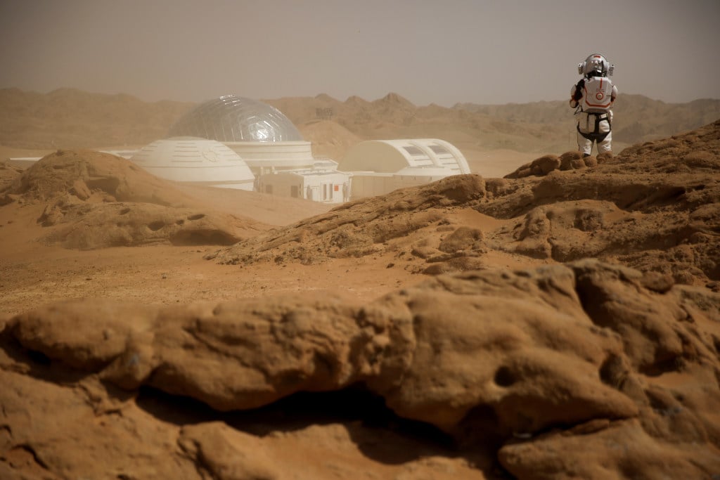 At the C-Space Project Mars simulation base in China’s Gobi Desert, a staff member poses in a mock space suit in April 2019. (Picture: Reuters)