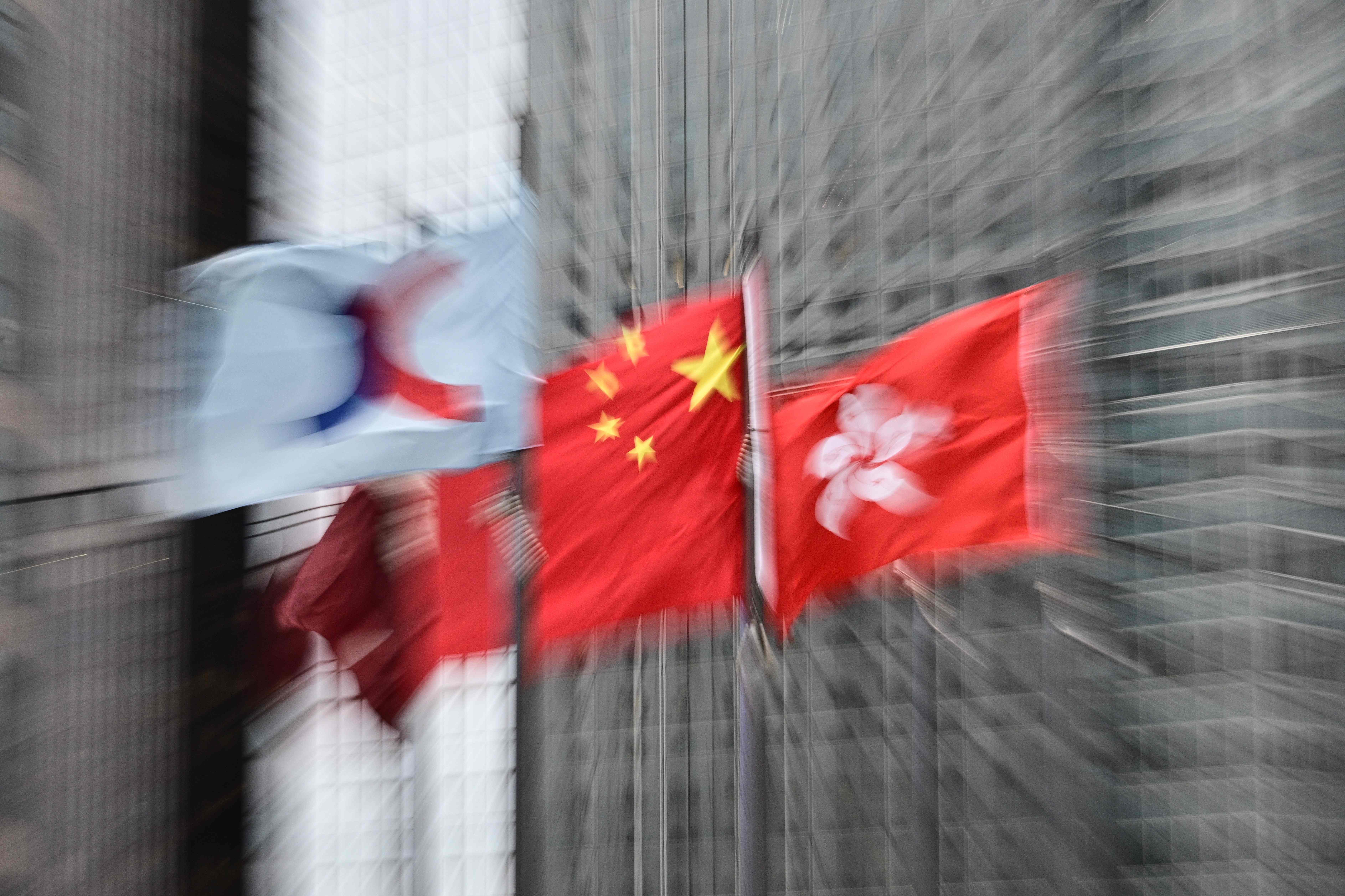 The flags of Hong Kong stock exchange, China and Hong Kong are seen outside Exchange Square in Hong Kong. Photo: AFP